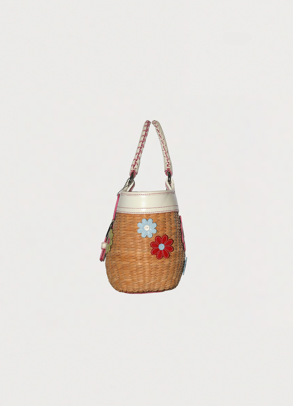 Vintage Coach Flowered straw handbag in white leather trim showing left side