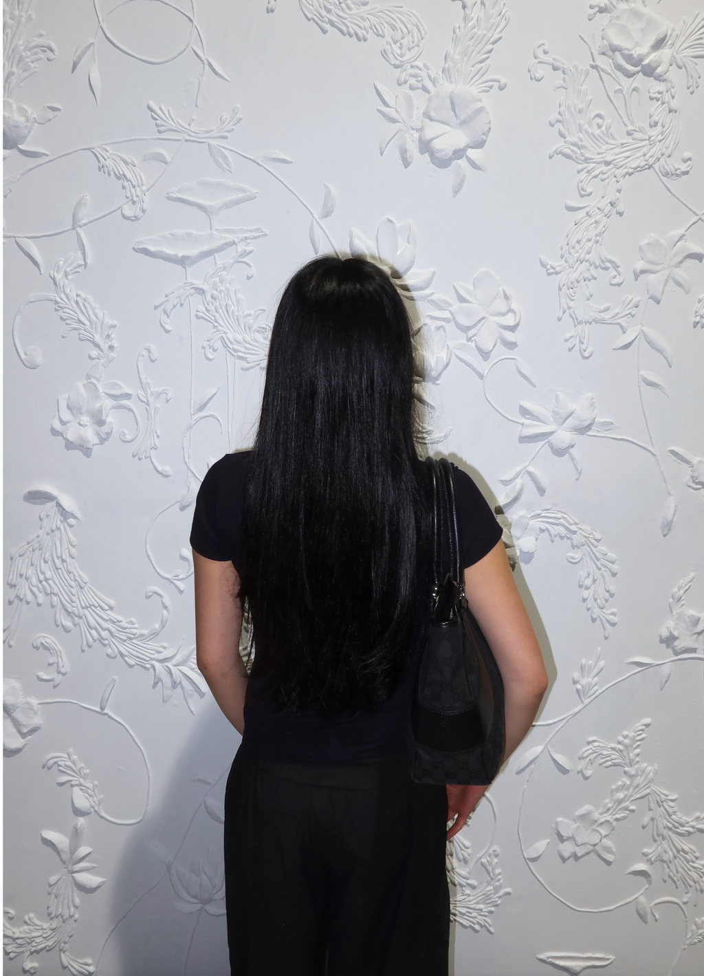 Black Gucci GG monogram tote bag worn on shoulder by model