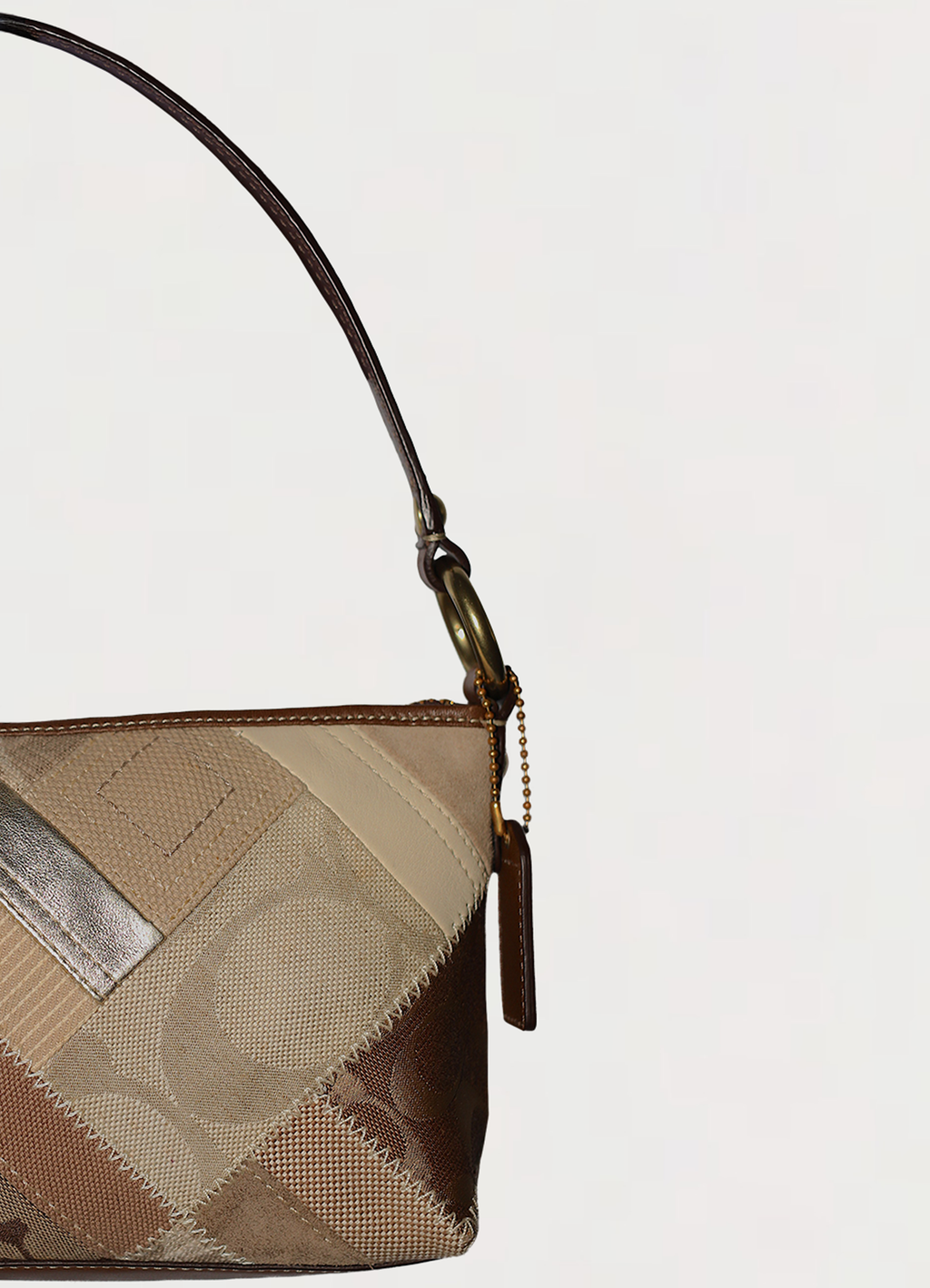 Vintage Coach Hamptons baguette bag in brown signature canvas with leather trim showing close up of left side