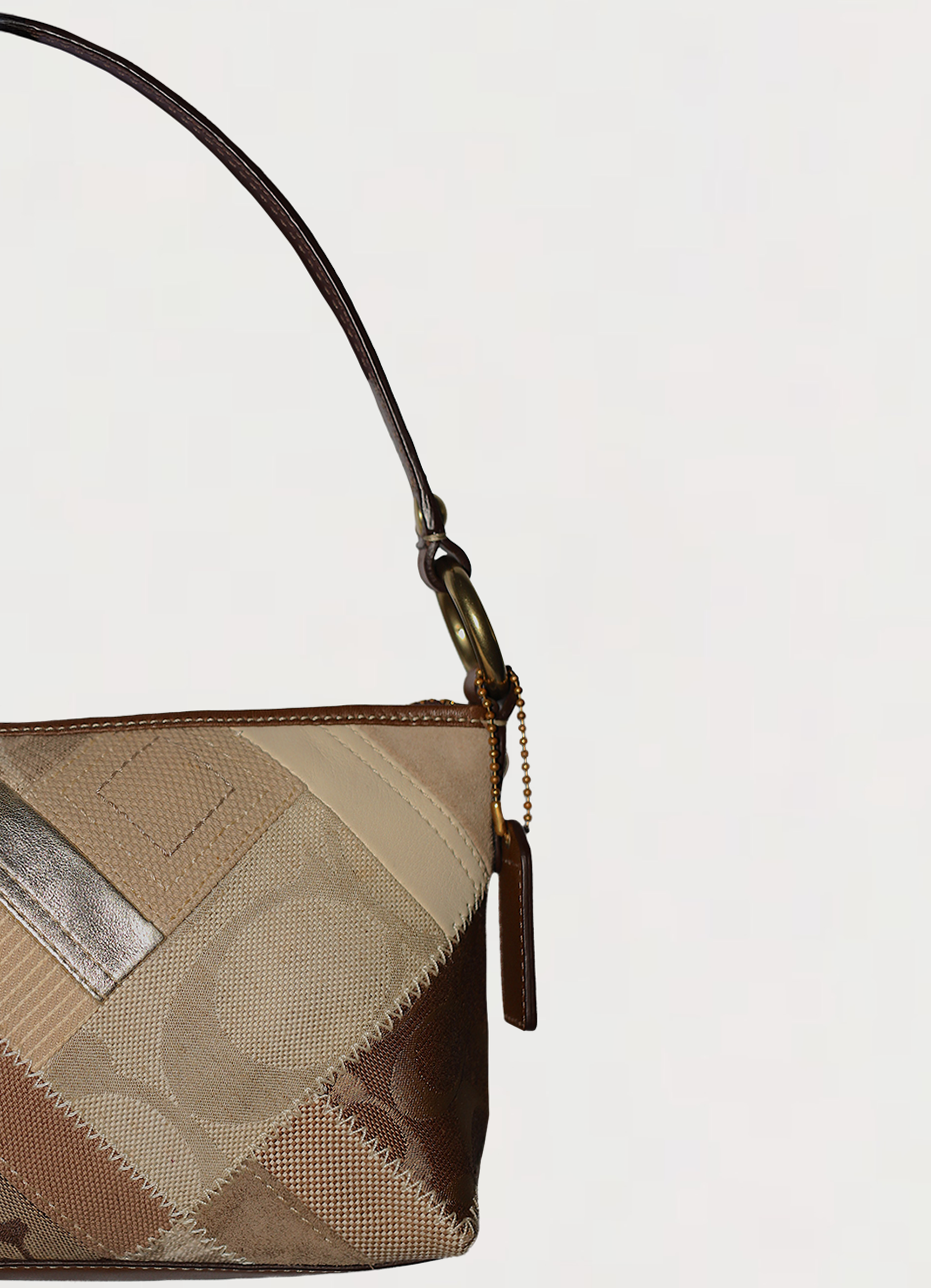 Vintage Coach Hamptons baguette bag in brown signature canvas with leather trim showing close up of left side