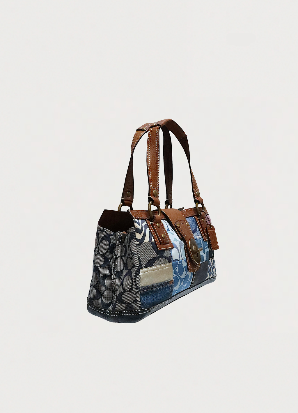 Angled view of Coach Hamptons patchwork bag showing varied material textures