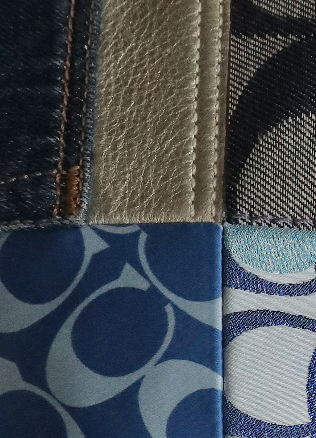 Close up of metallic leather and denim signature pattern patchwork on Coach bag