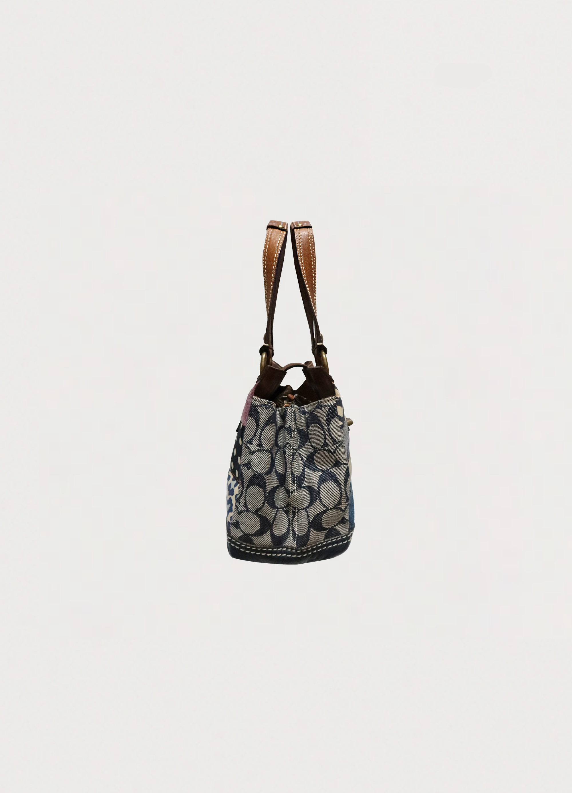 Left side profile of Coach Hamptons patchwork satchel bag