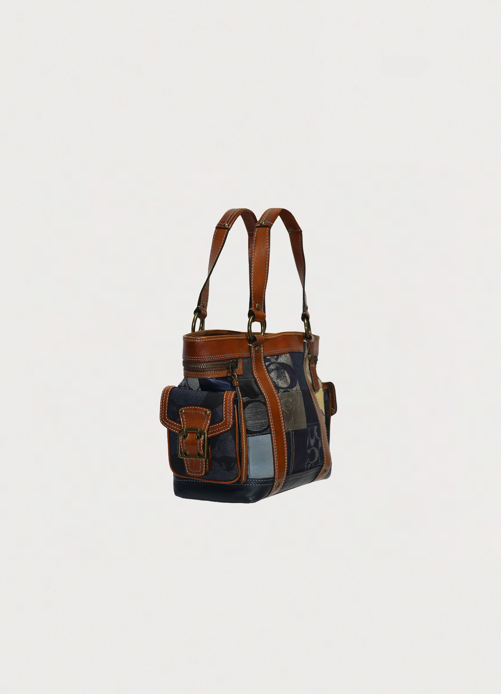 Vintage Coach Legacy denim tote bag in blue signature canvas with leather trim showing angled side
