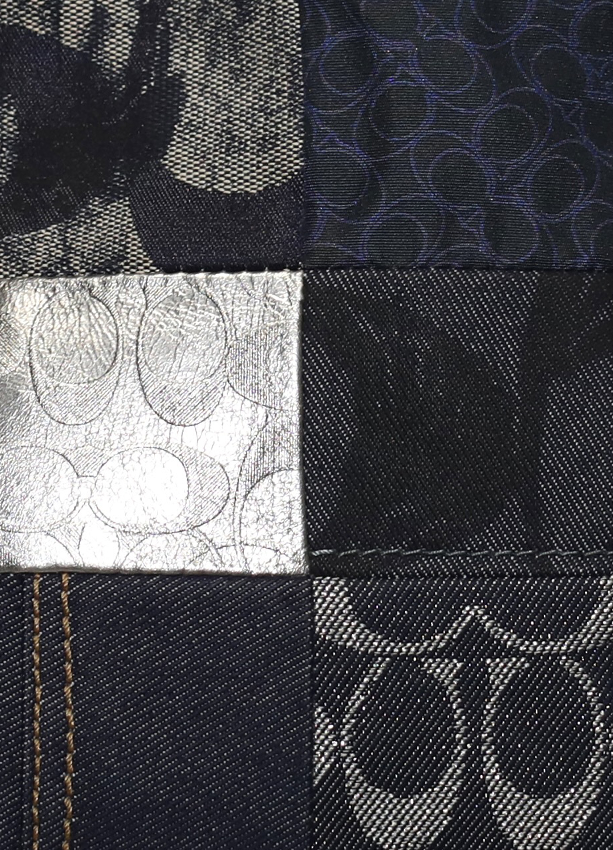 Vintage Coach Legacy denim tote bag in blue signature canvas with leather trim showing close up of print