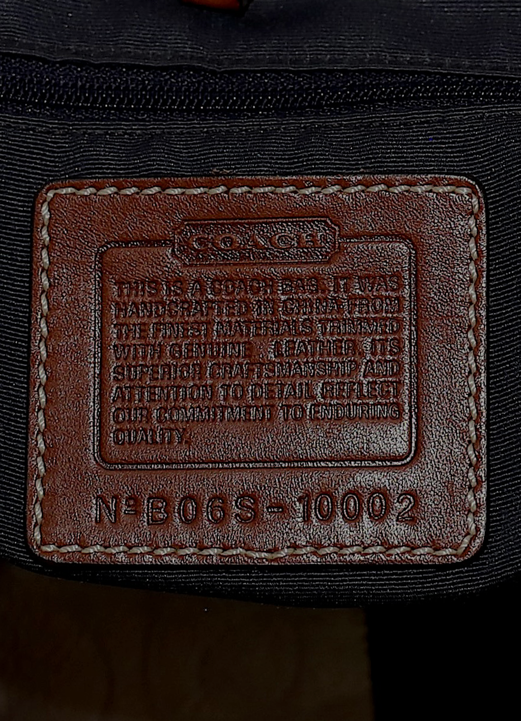 Vintage Coach Legacy denim tote bag in blue signature canvas with leather trim showing close up of creed patch