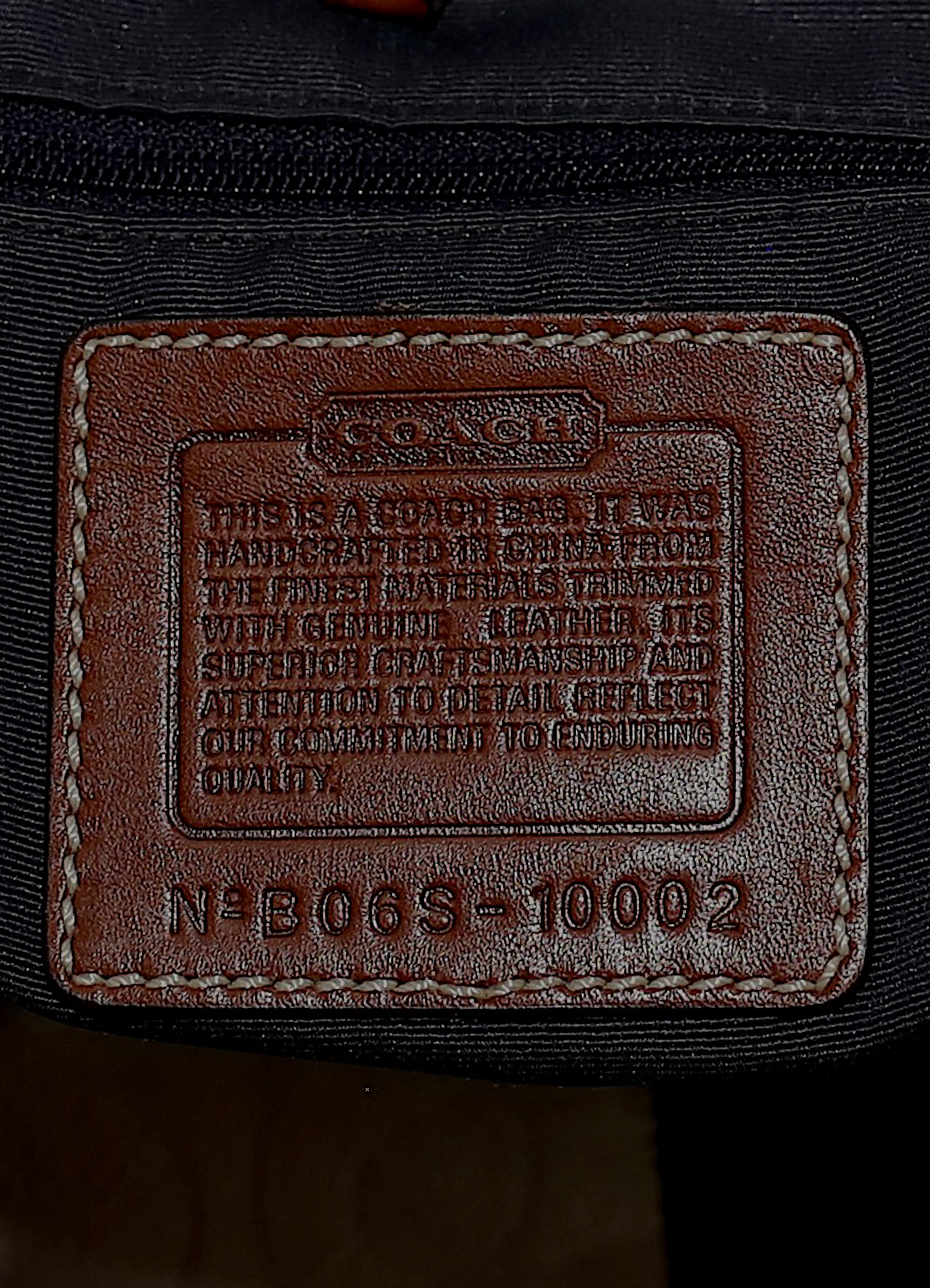Vintage Coach Legacy denim tote bag in blue signature canvas with leather trim showing close up of creed patch