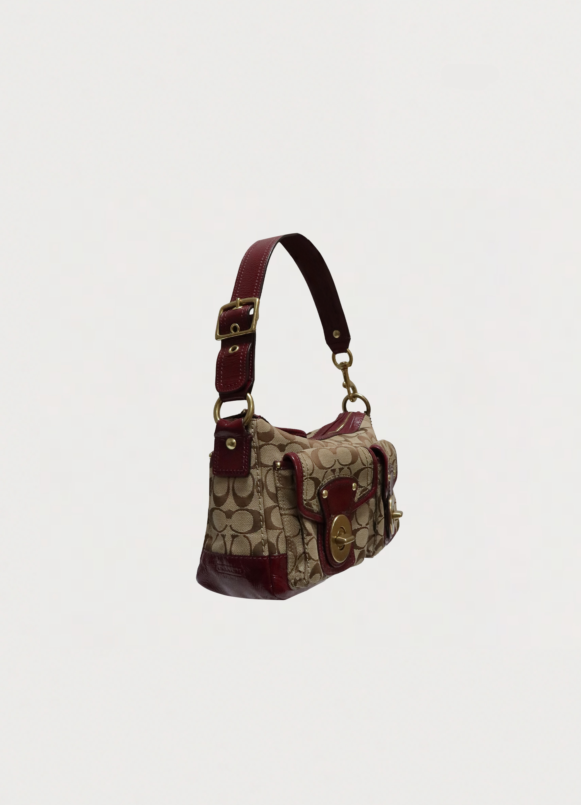 Angled view of Coach Legacy turnlock pouch showing front pocket detail