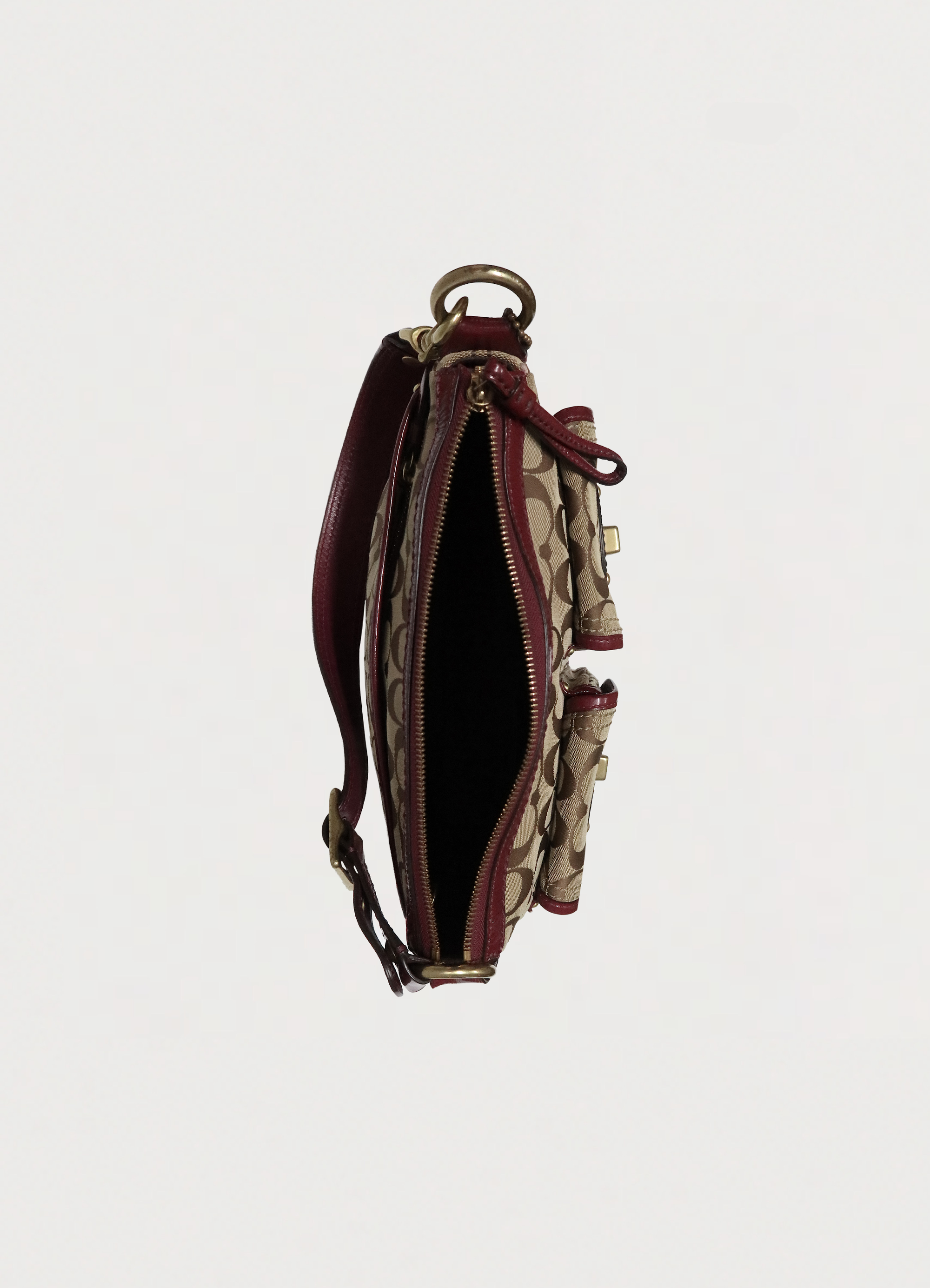 Top view of khaki Coach pouch showing interior compartment and zipper
