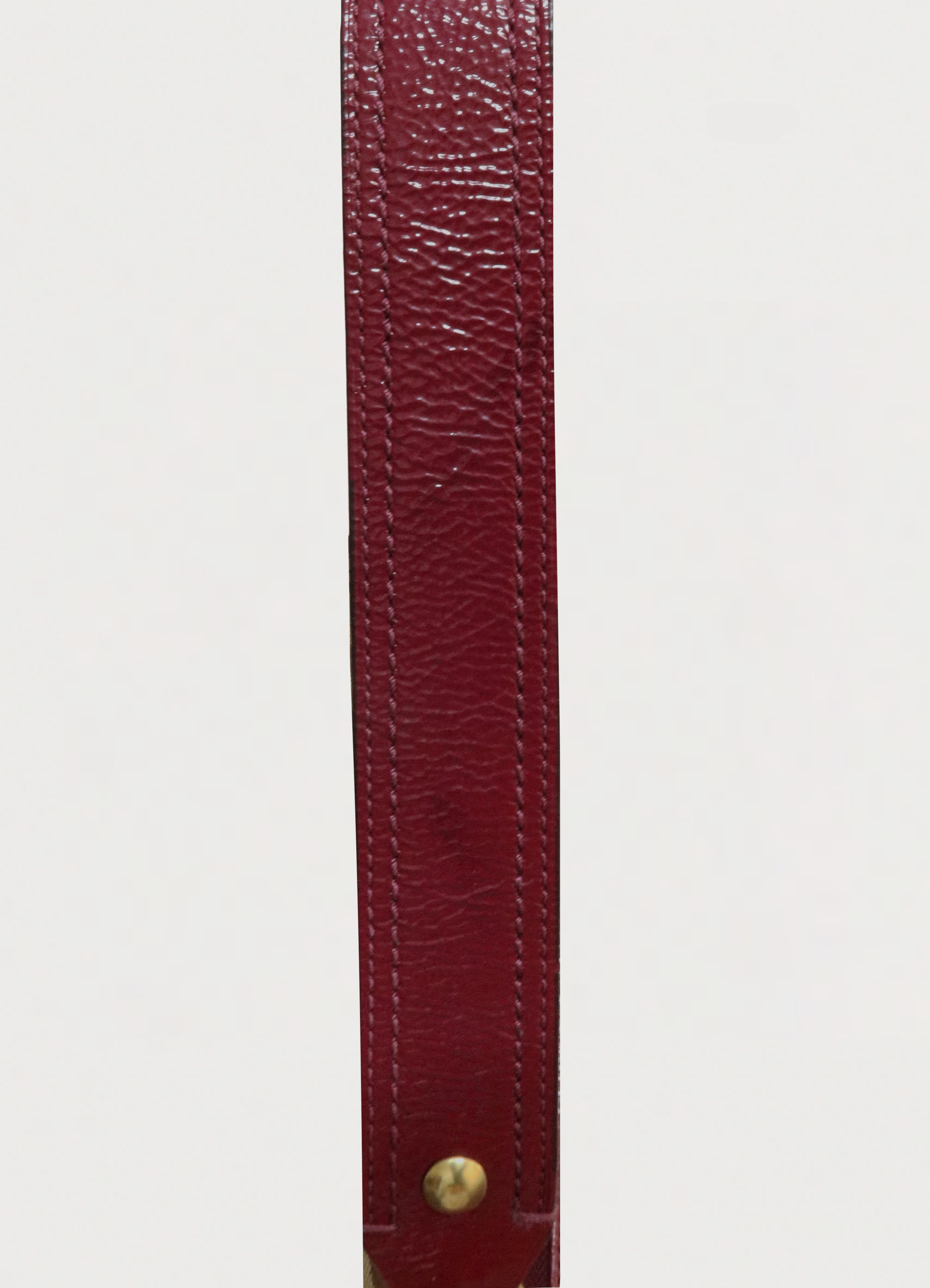 Top view of the beet red leather shoulder strap for Coach Legacy pouch