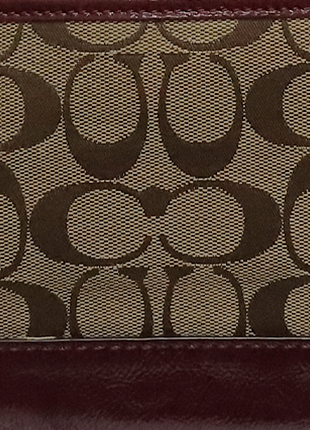 Macro shot of authentic khaki Coach signature jacquard canvas
