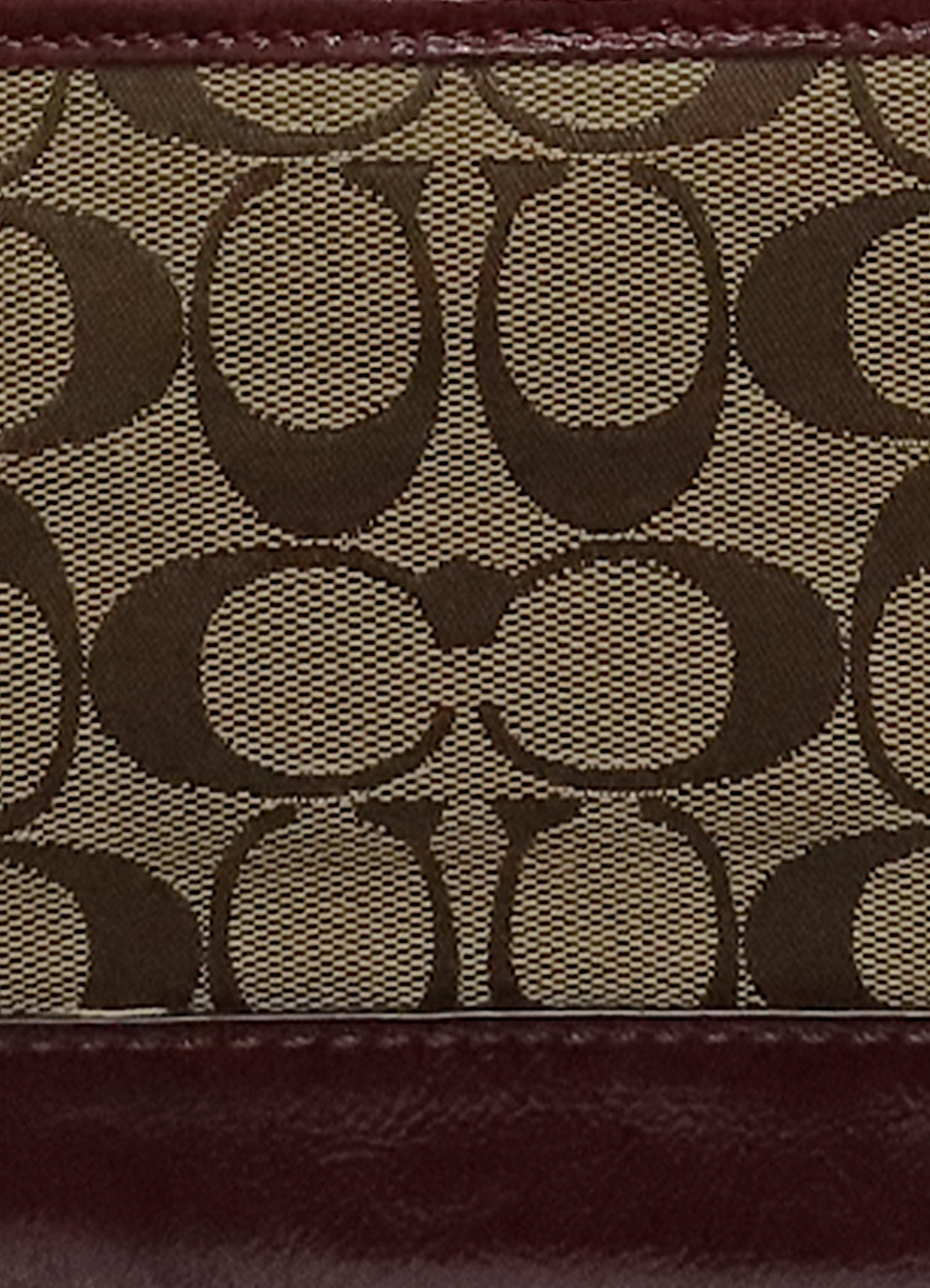 Macro shot of authentic khaki Coach signature jacquard canvas