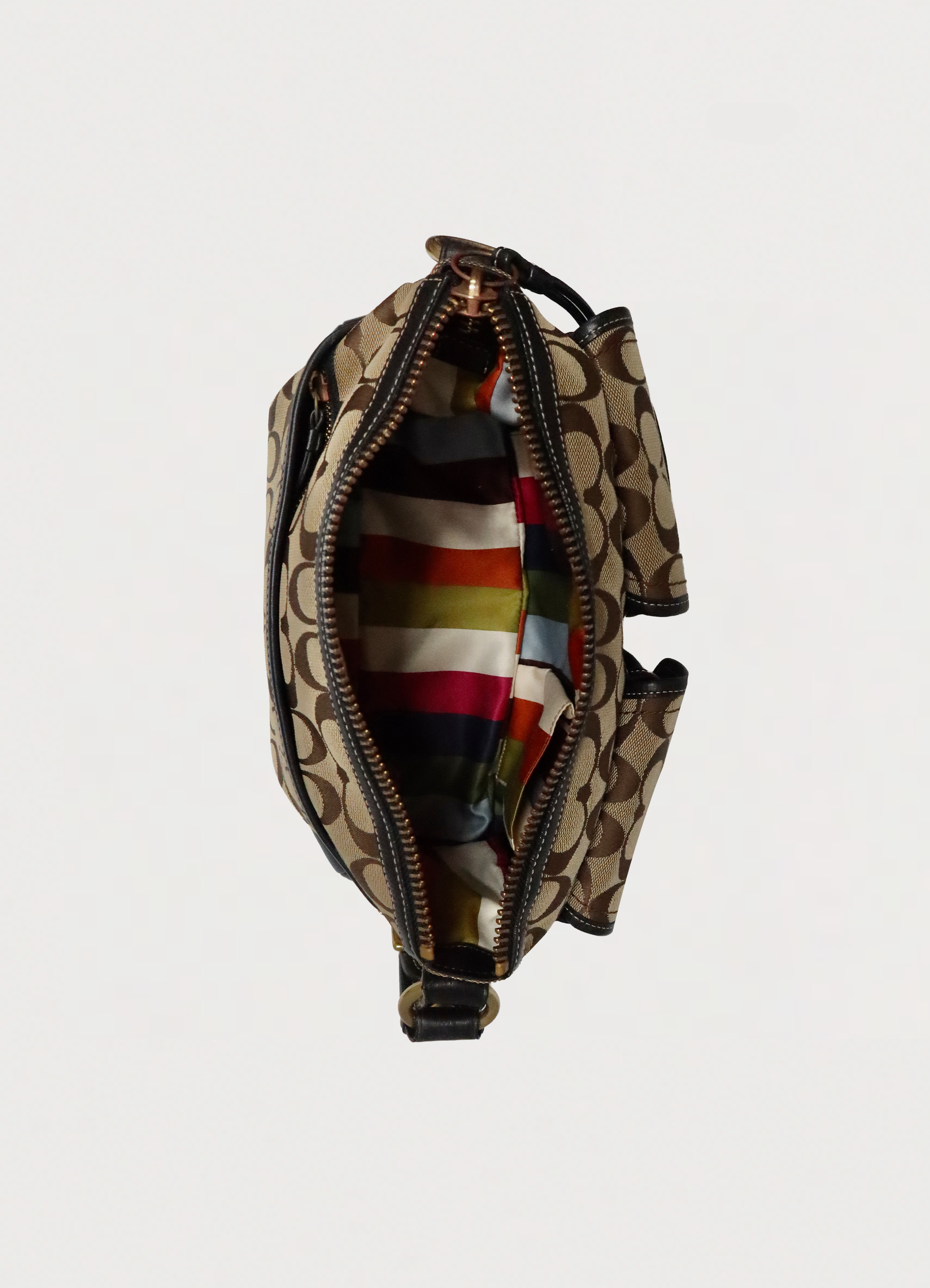 Top view of Coach Legacy satchel showing multi-color Legacy stripe silk lining