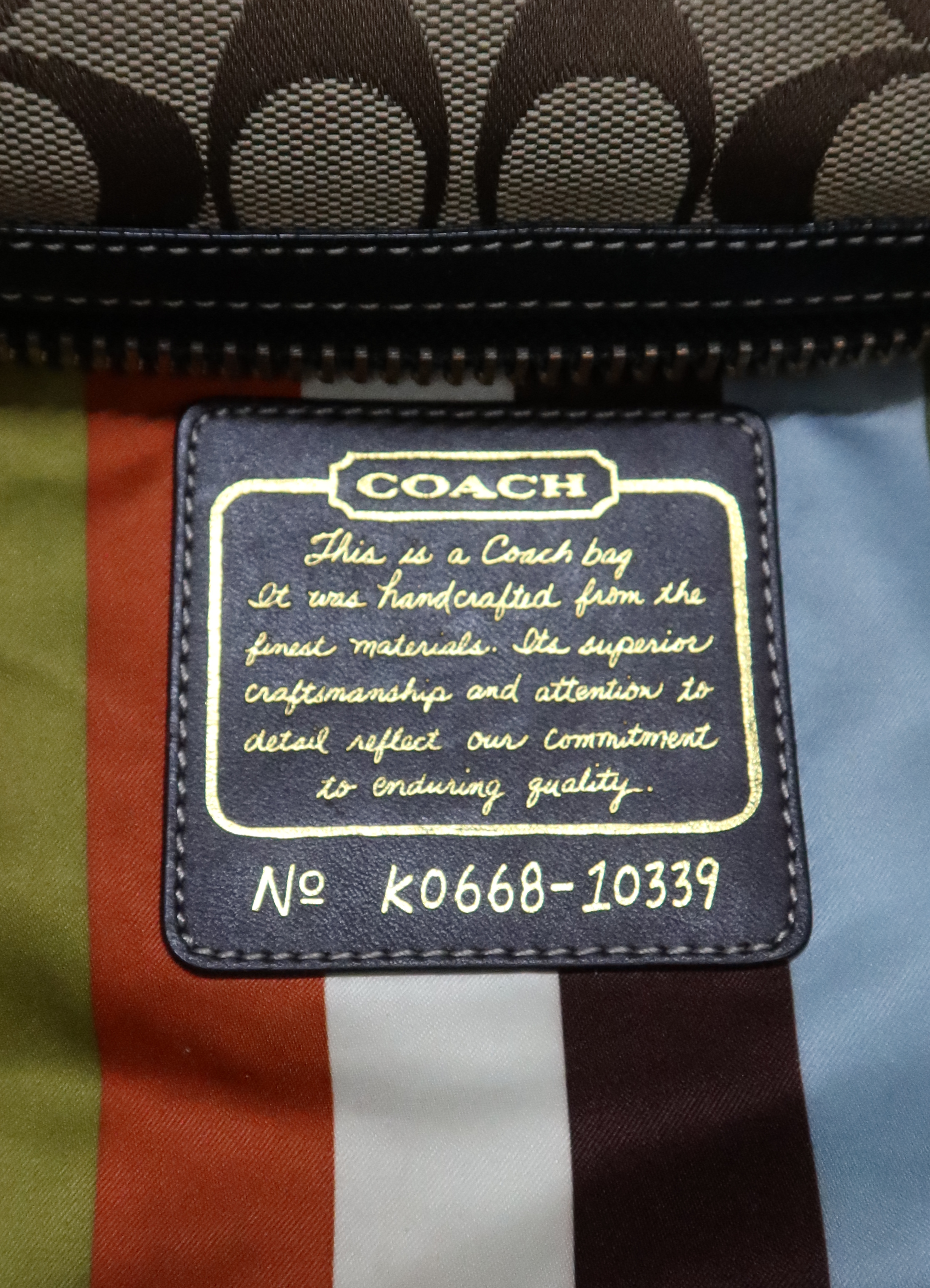 Interior leather Coach creed patch with style number 10339 against Legacy stripe lining