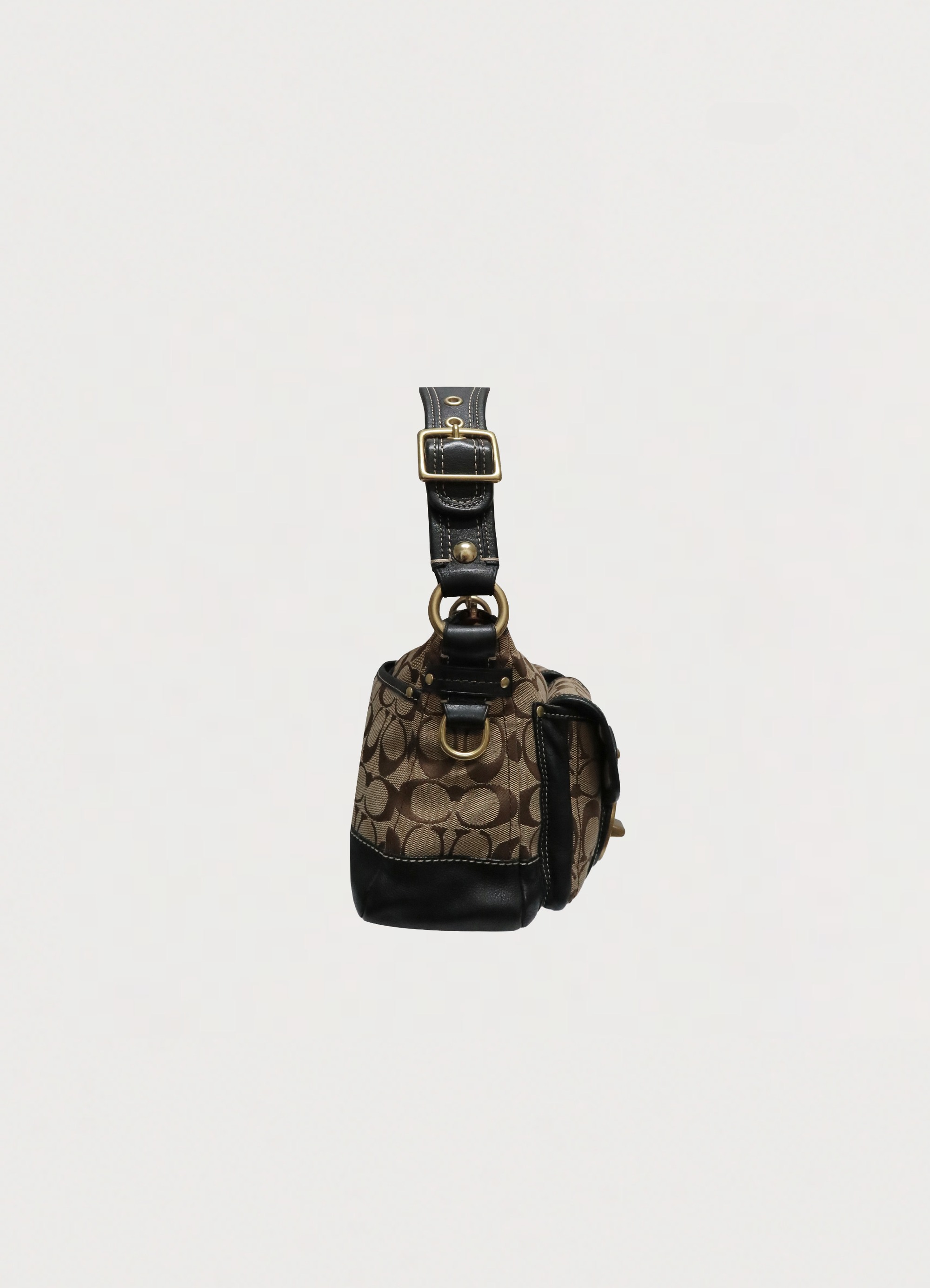 Right side profile of khaki Coach Legacy satchel showing dual front pocket structure