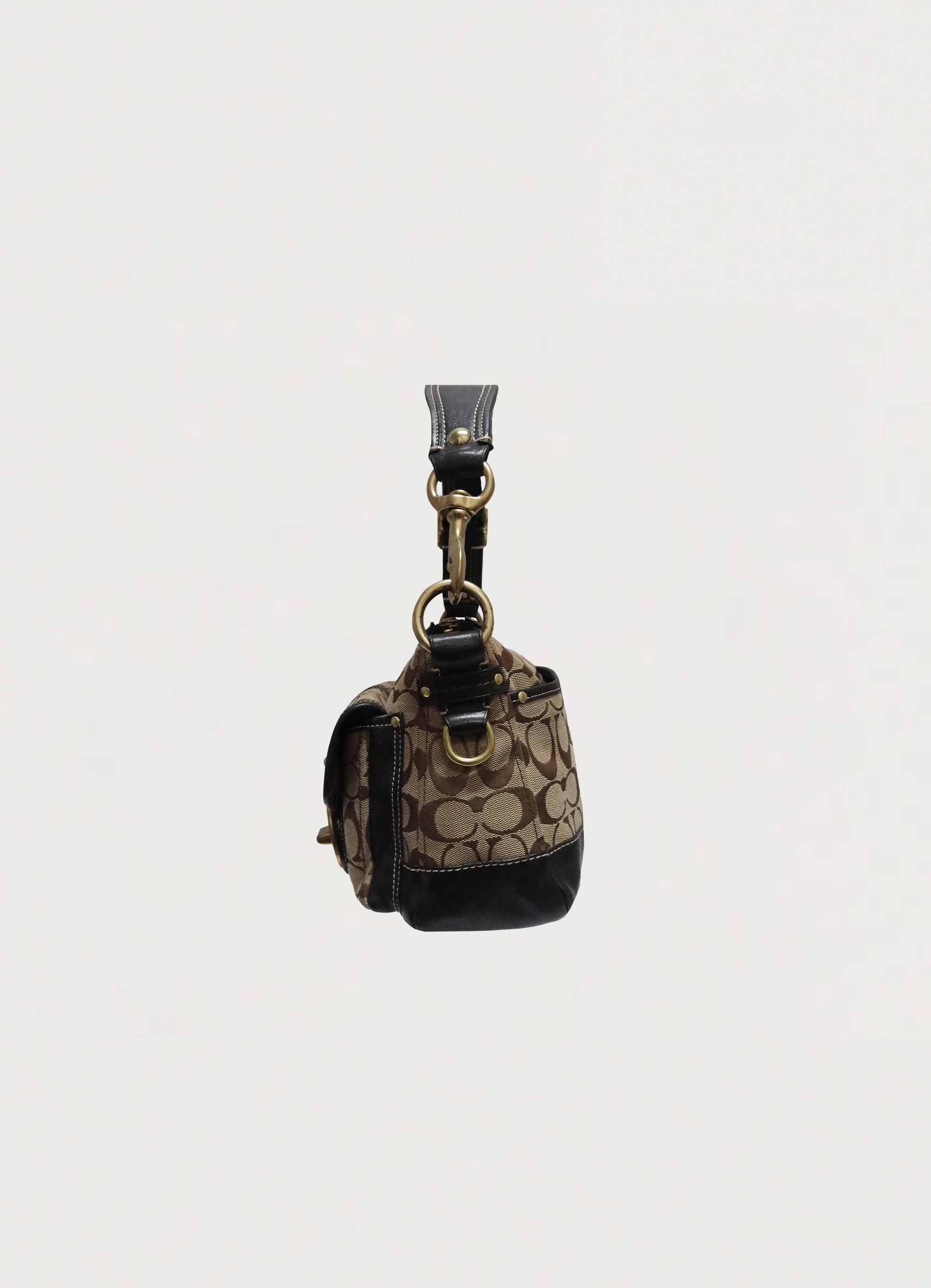 Left side profile of khaki Coach Legacy satchel showing leather trim and brass hardware