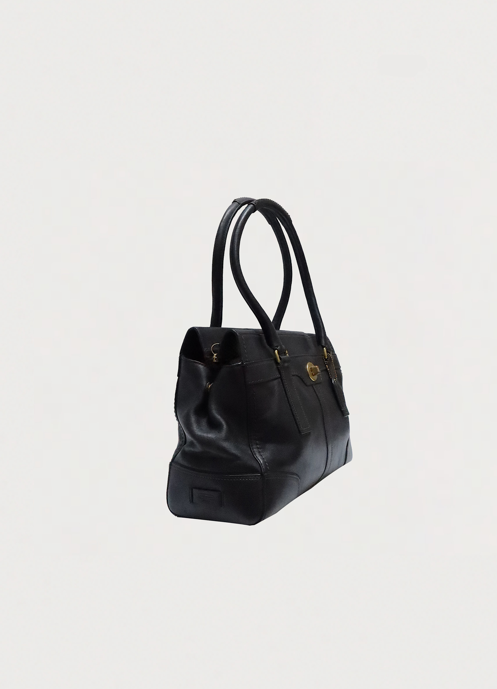 Angled side view of Coach Madeline black leather bag showing structured shape