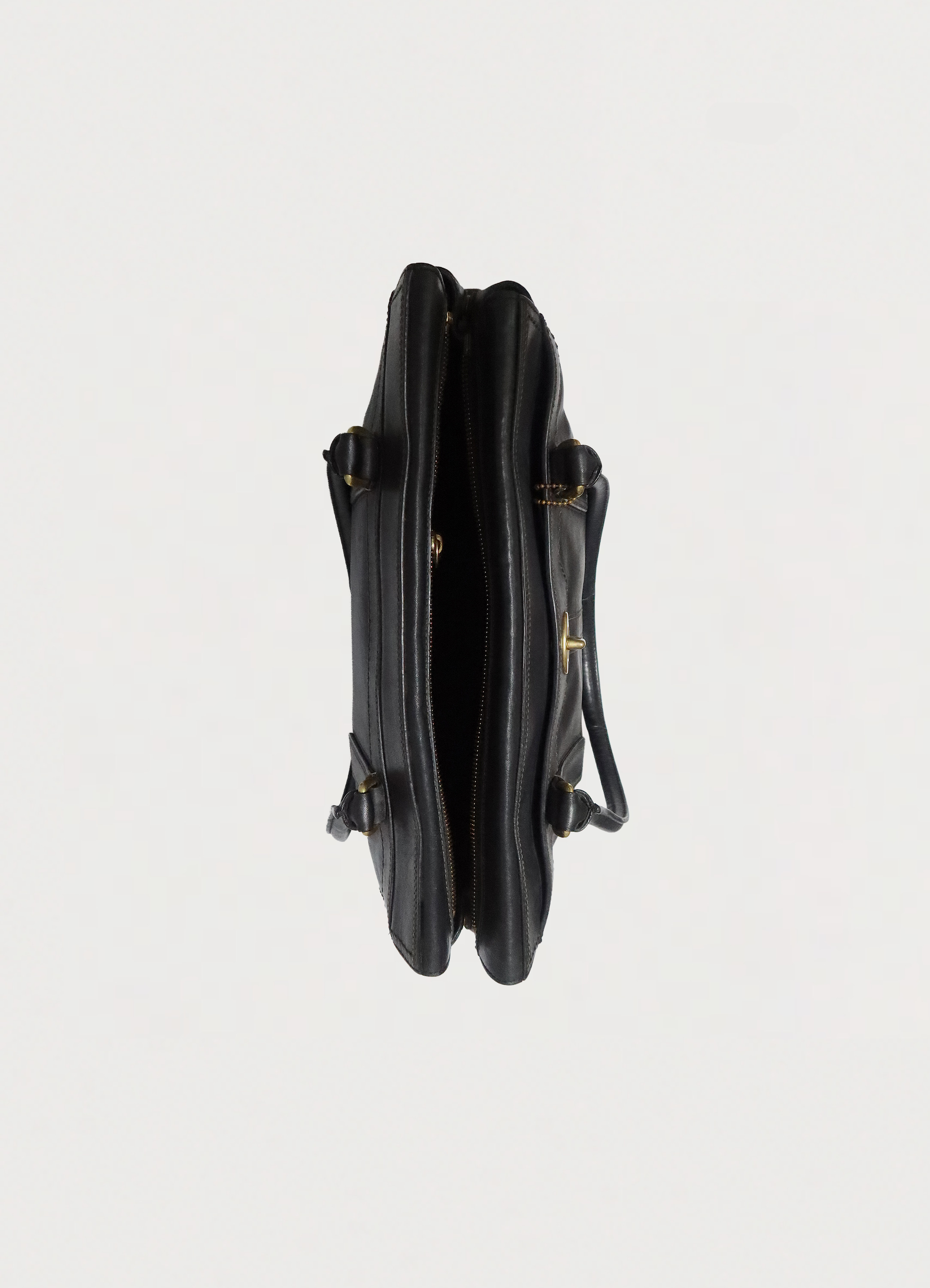Top view of black Coach Madeline bag showing interior compartment and zip opening