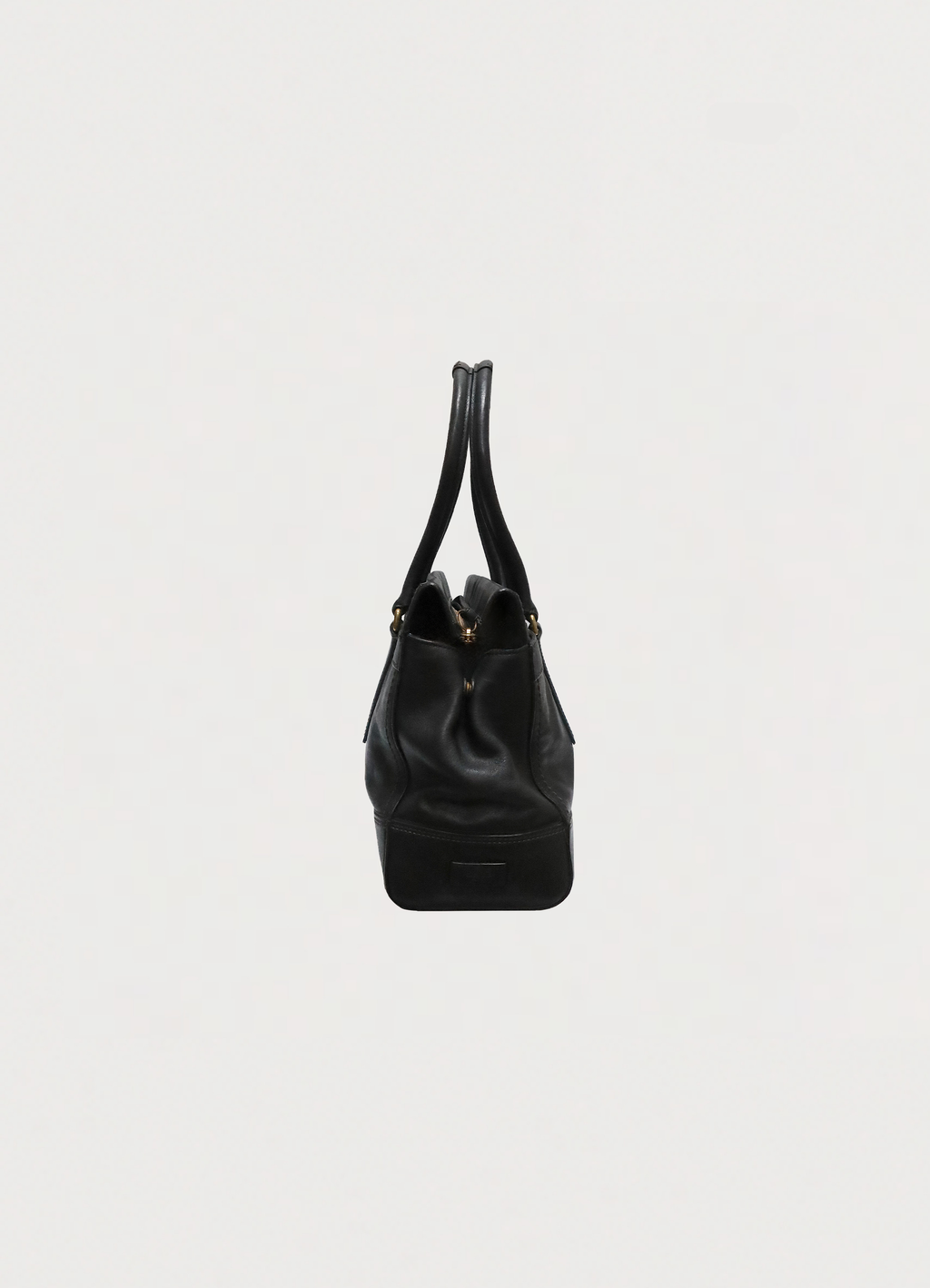 Right side profile of black leather Coach Madeline satchel shoulder bag