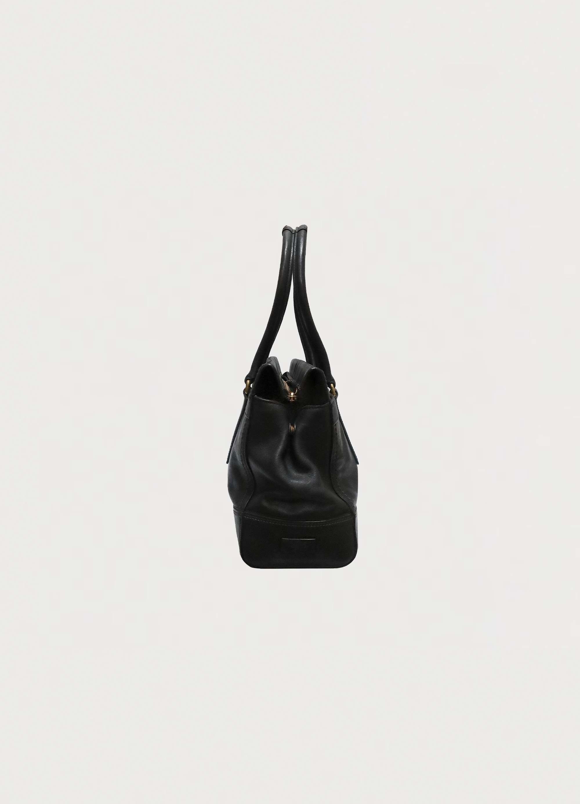 Right side profile of black leather Coach Madeline satchel shoulder bag