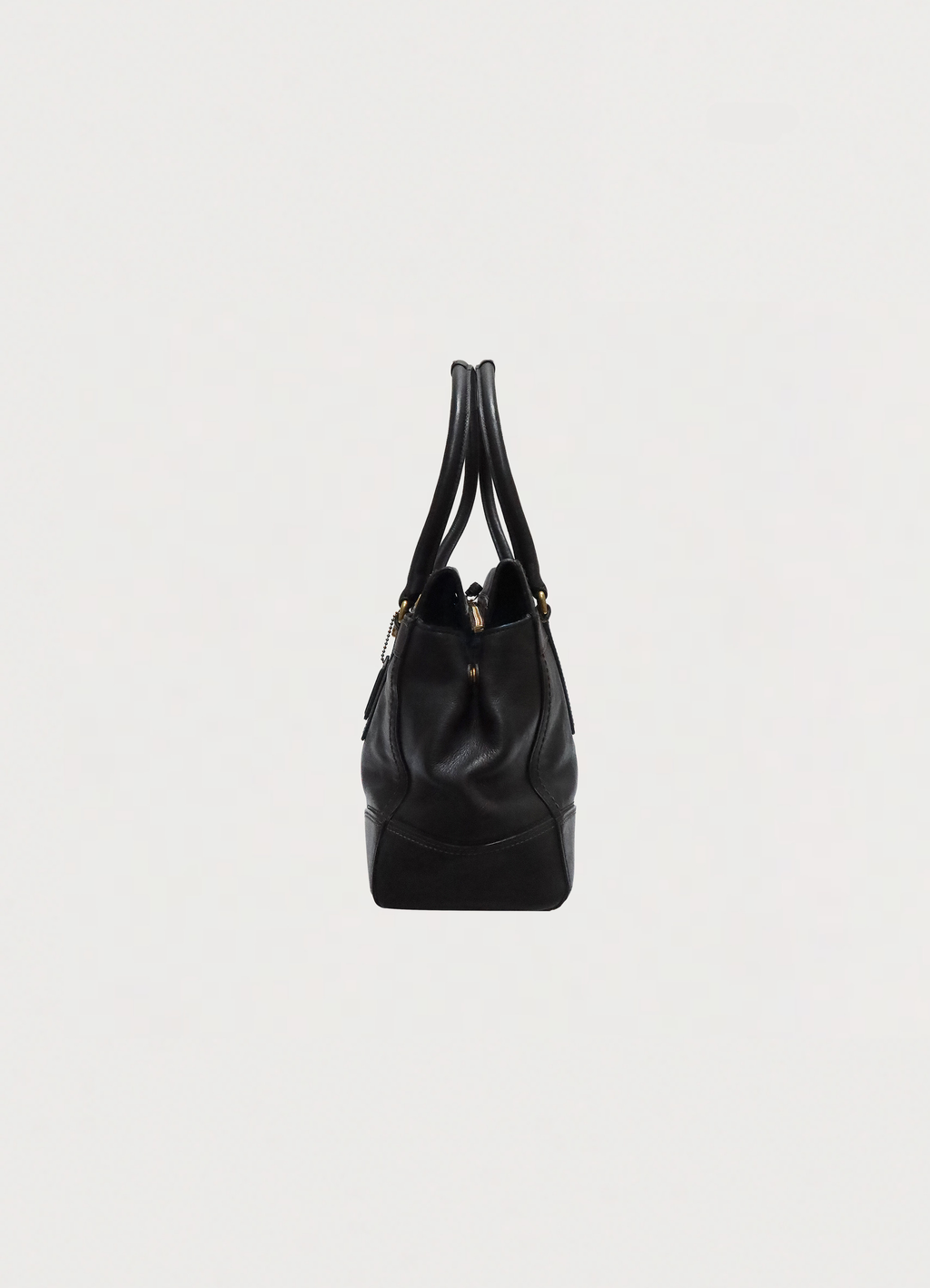 Left side profile of black leather Coach Madeline satchel shoulder bag