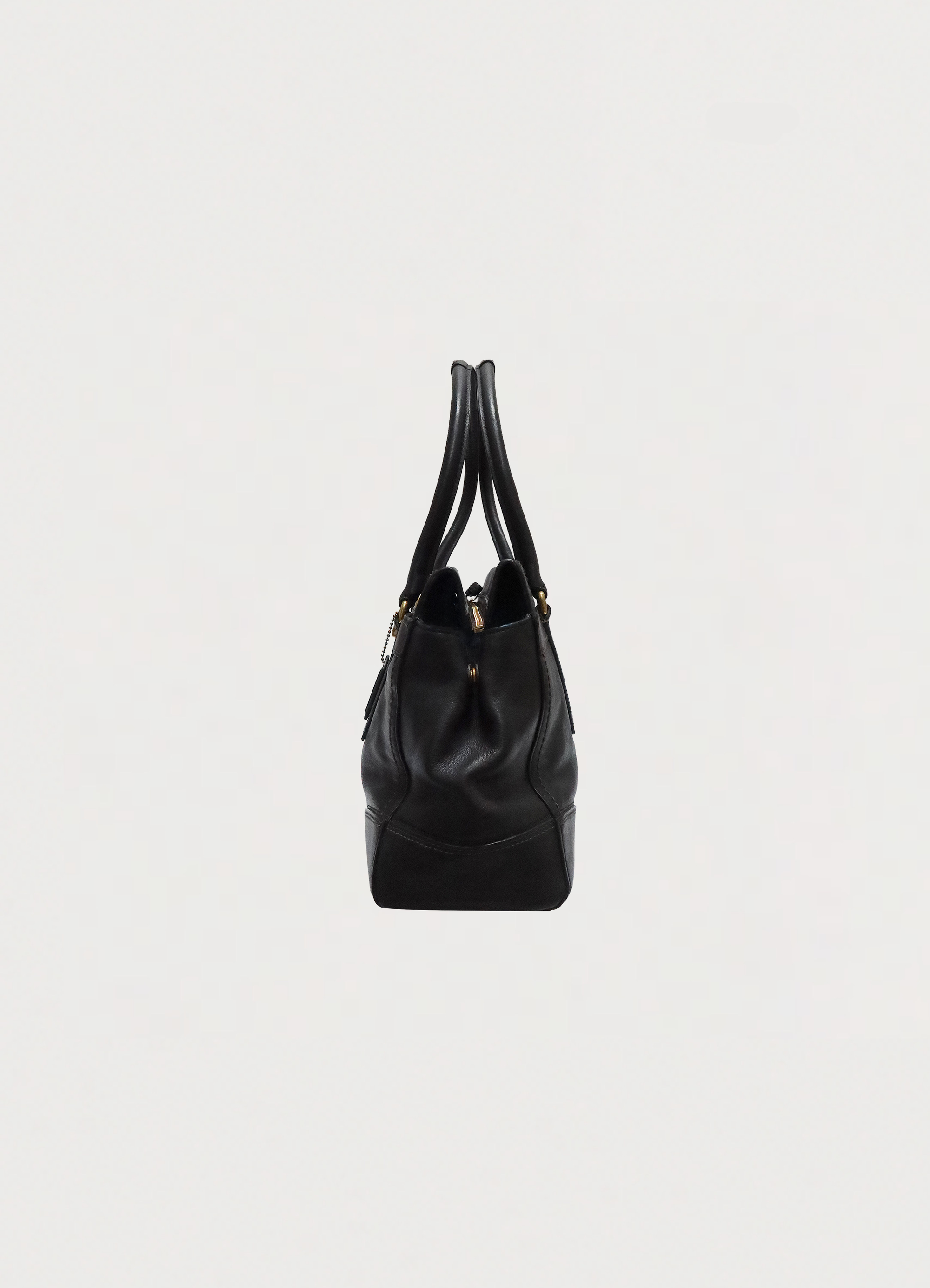 Left side profile of black leather Coach Madeline satchel shoulder bag