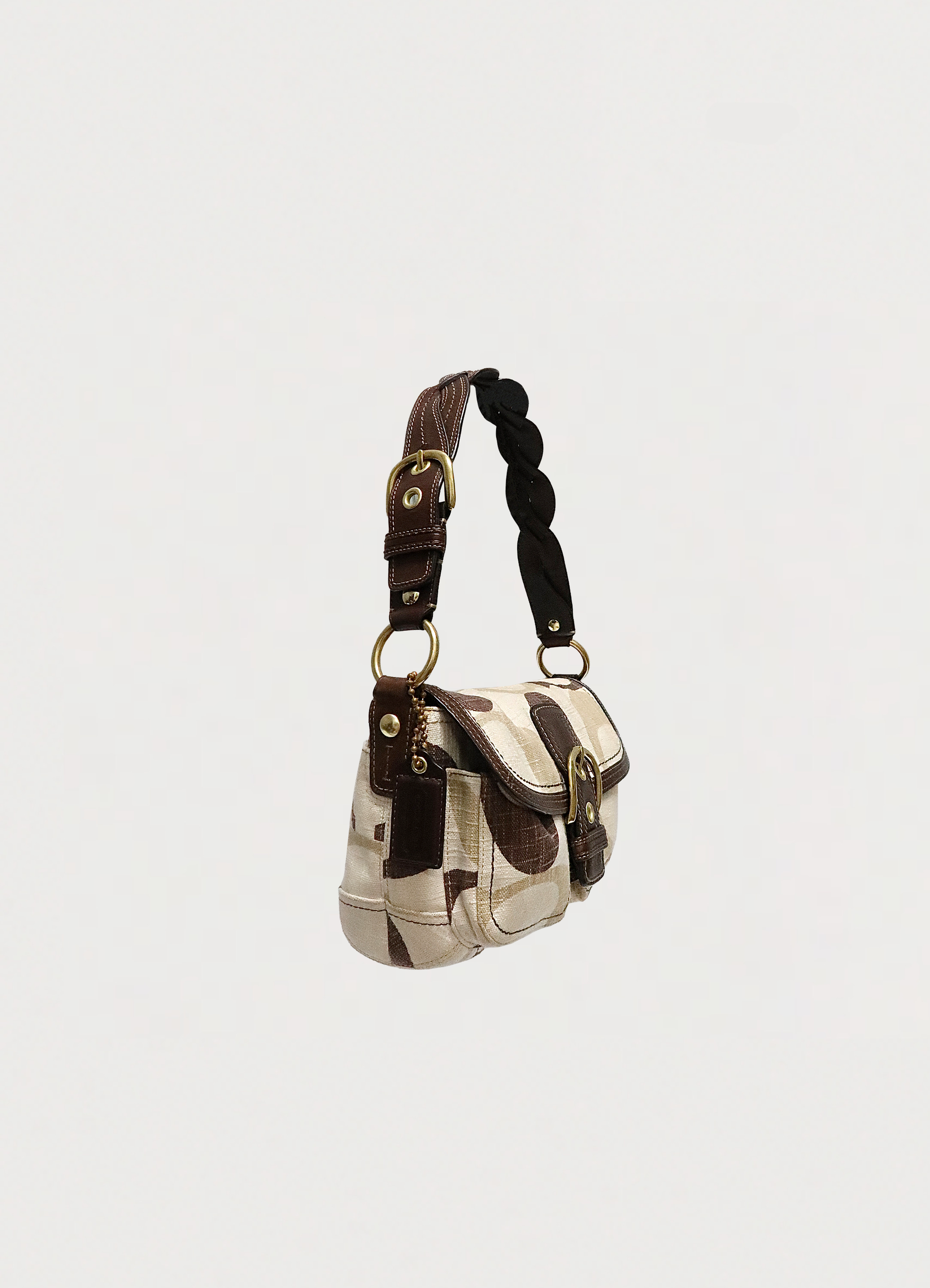 Angled side view of Coach Soho flap bag showing bag depth and leather trim