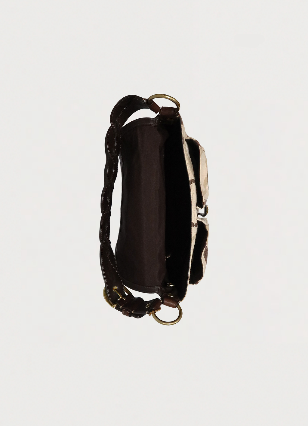 Top view of Coach Soho flap bag showing dark brown fabric interior
