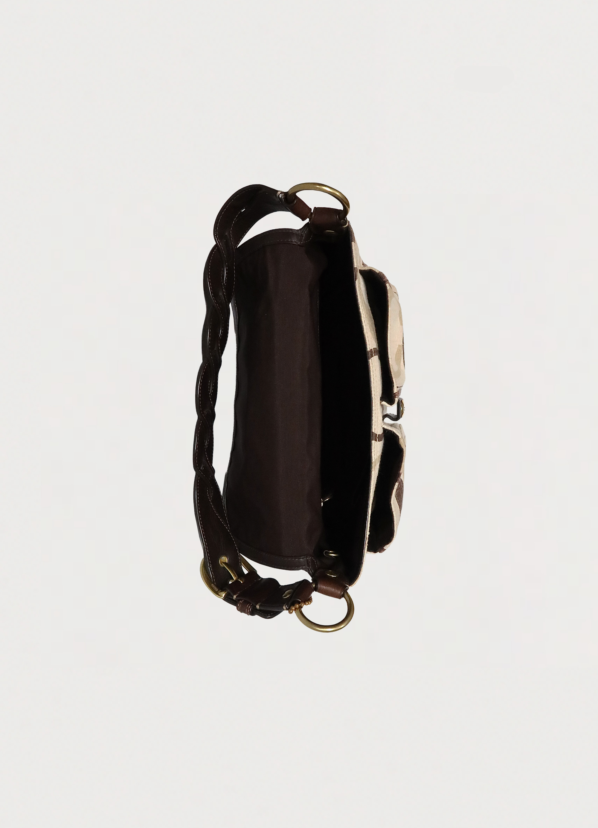 Top view of Coach Soho flap bag showing dark brown fabric interior