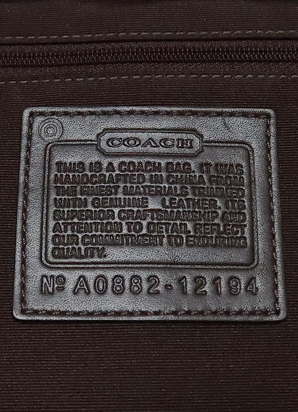 Interior leather Coach creed patch showing style number for authenticity