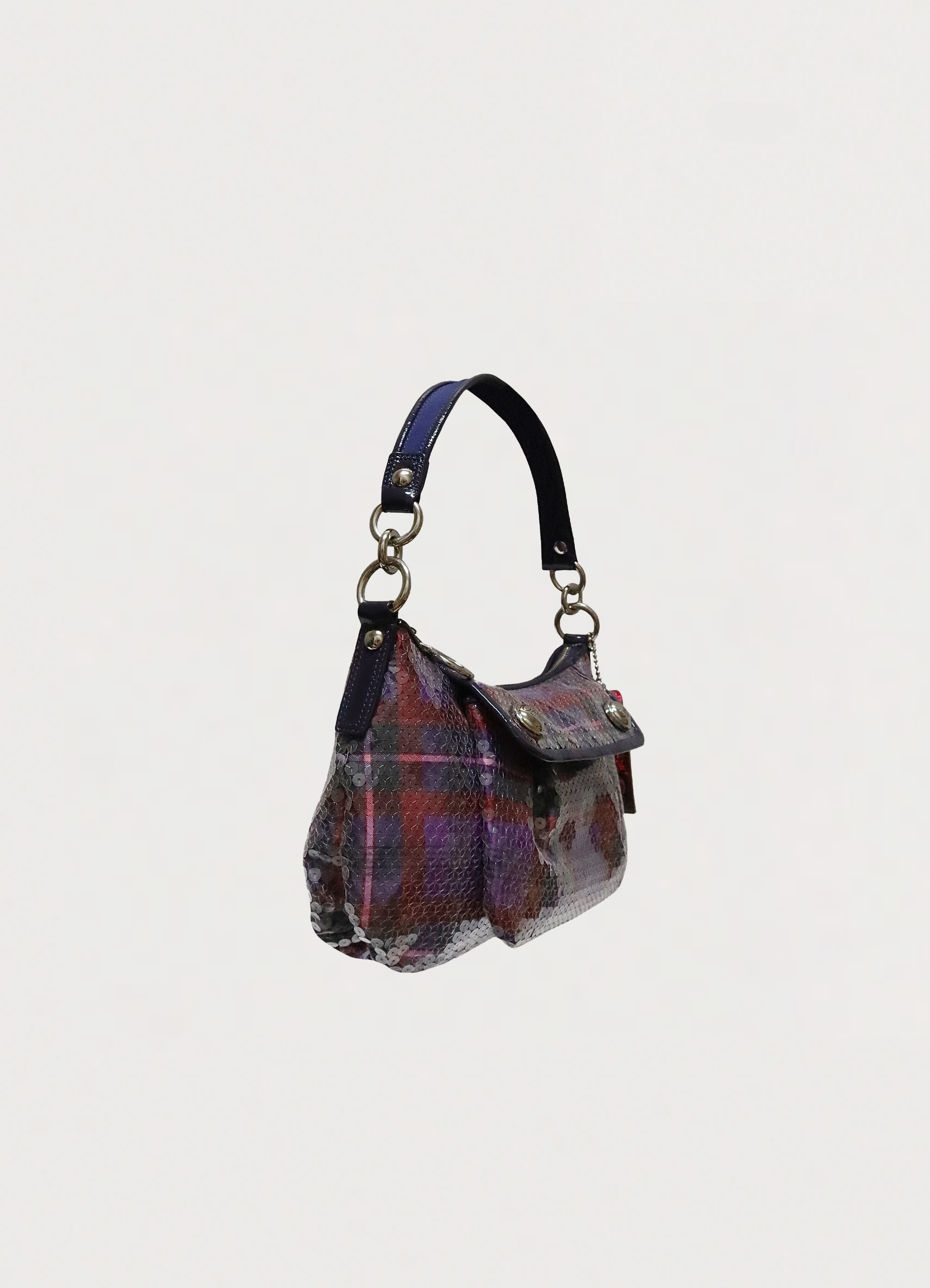 Angled side view of Coach Poppy Groovy bag showing sequin texture and bag depth