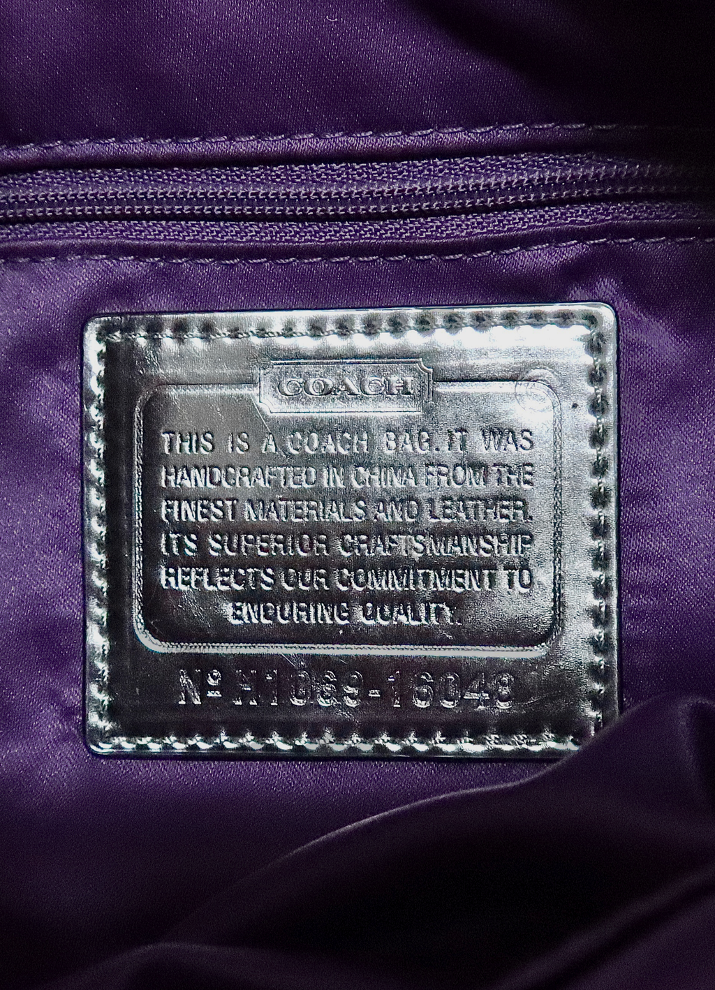 Interior silver leather Coach creed patch with serial number for authenticity