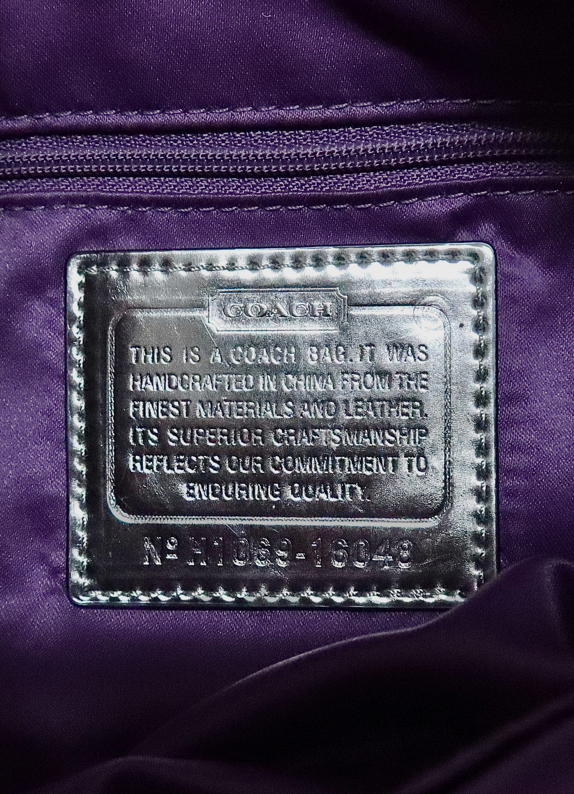 Interior silver leather Coach creed patch with serial number for authenticity