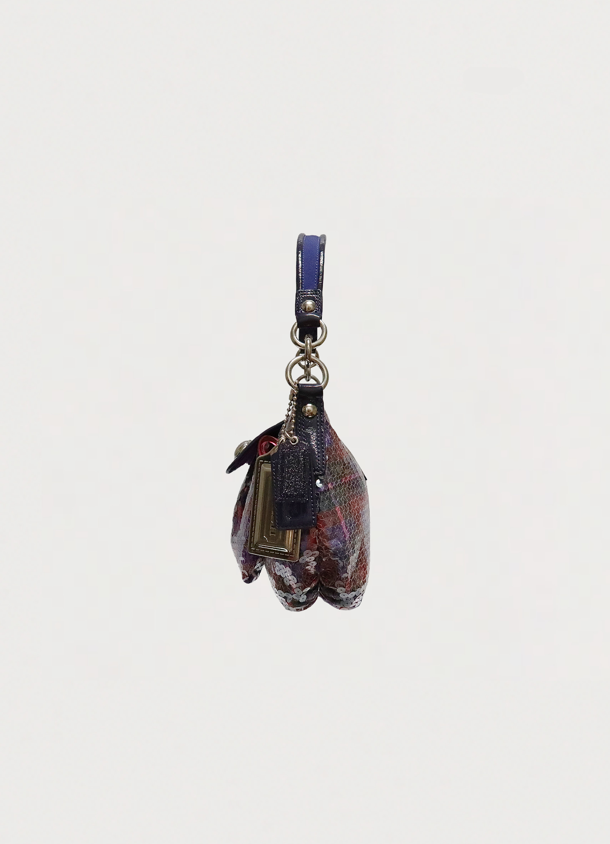 Right side profile of purple Coach Poppy Groovy sequin plaid bag