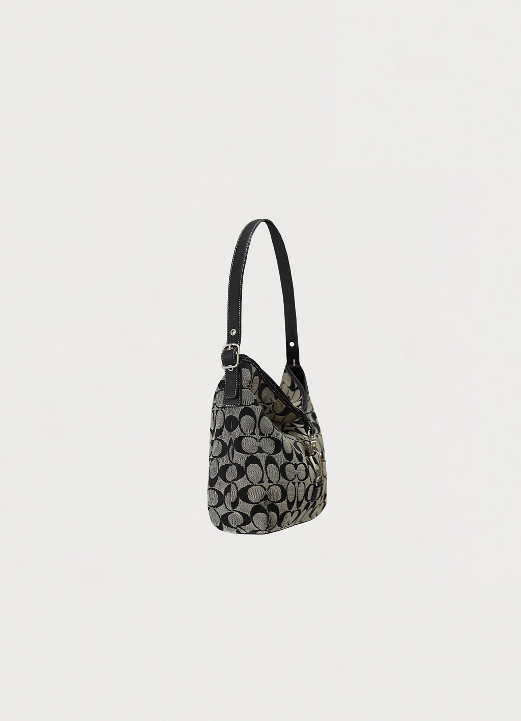 Angled side view of Coach black signature hobo bag showing bag depth