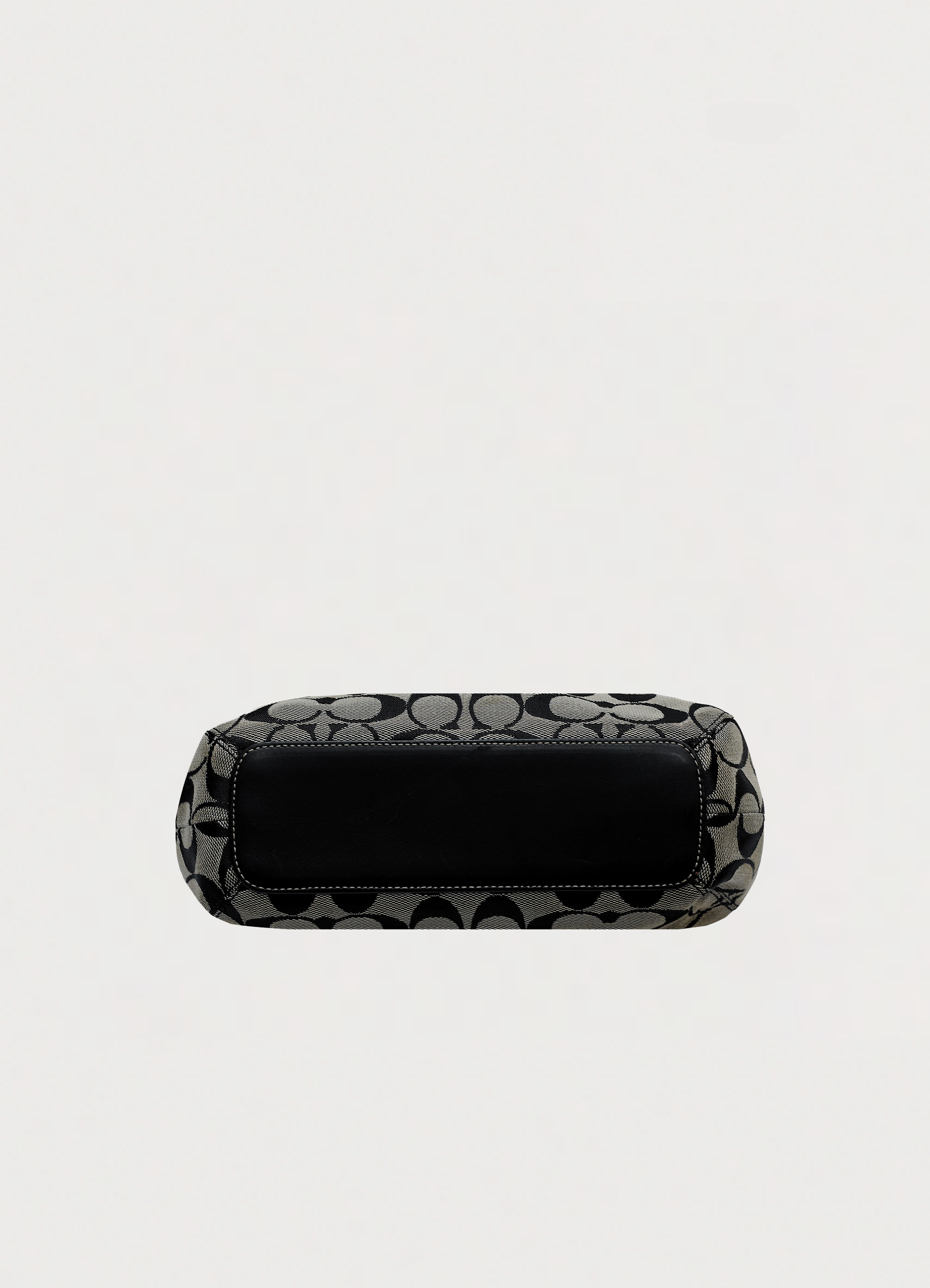 Base view of Coach Signature clip hobo bag showing leather bottom