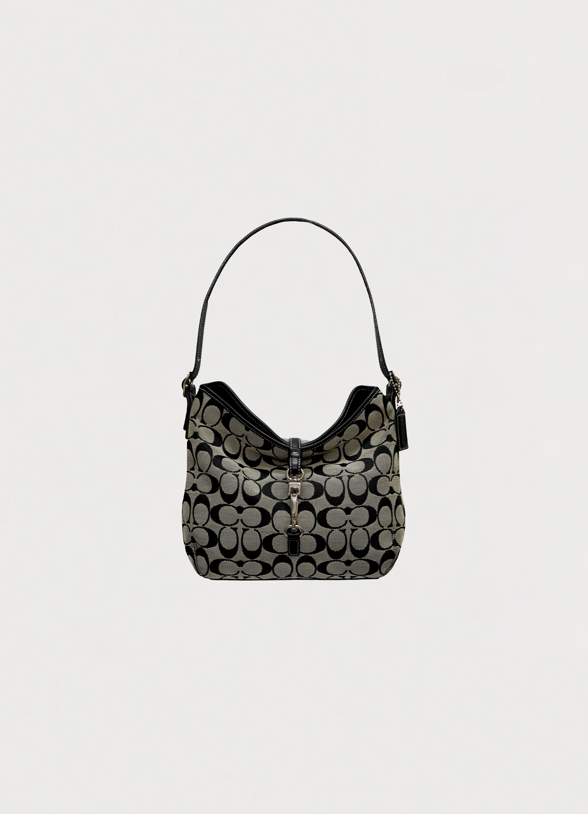 Vintage Coach Signature clip hobo bag in black and grey canvas front view showing vertical clip