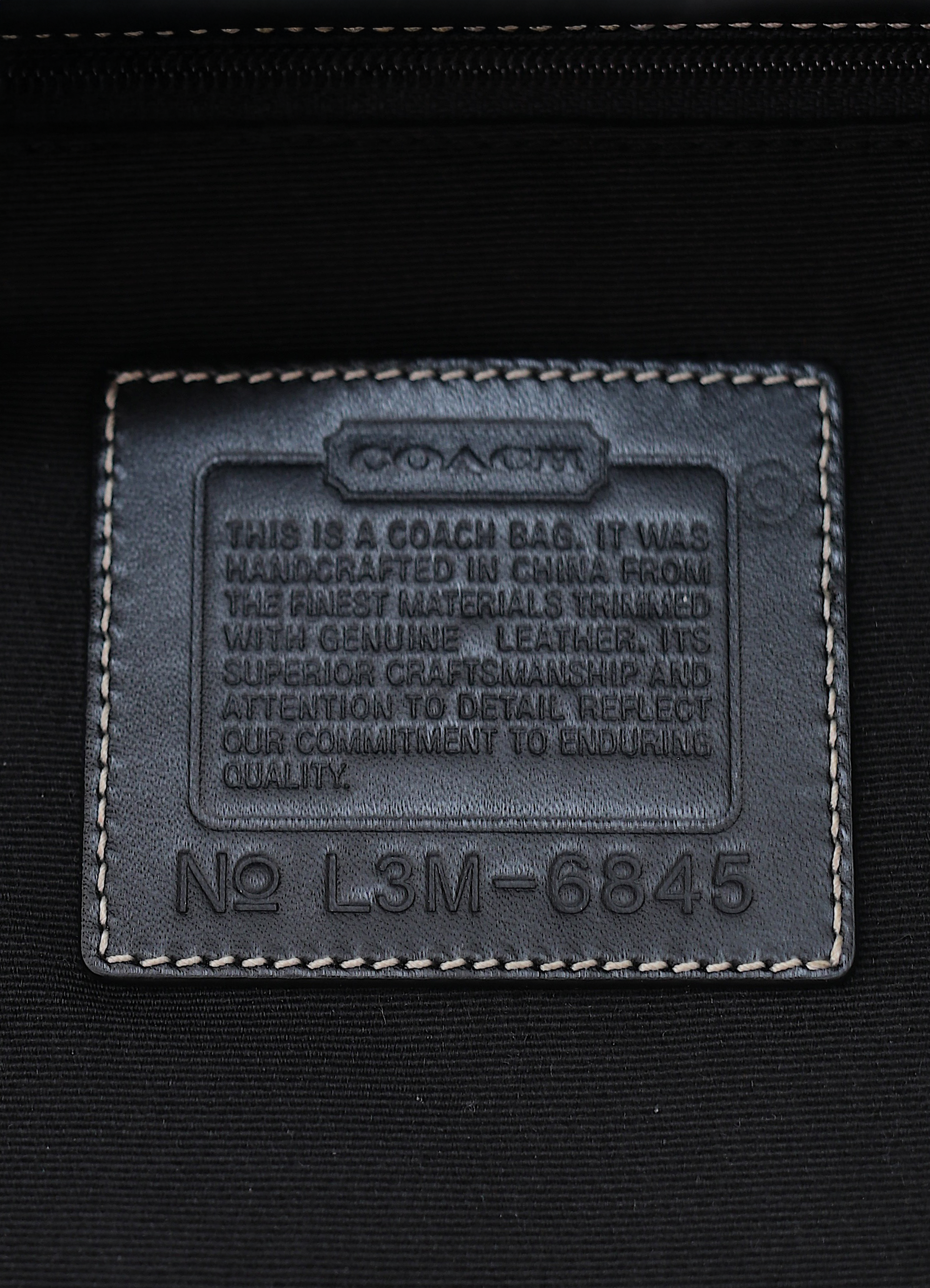 Interior leather Coach creed patch showing style number for authenticity