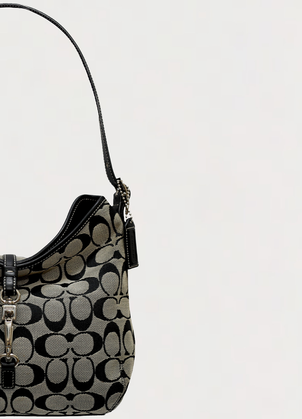 Close up of the black leather shoulder strap and hardware on Coach hobo bag