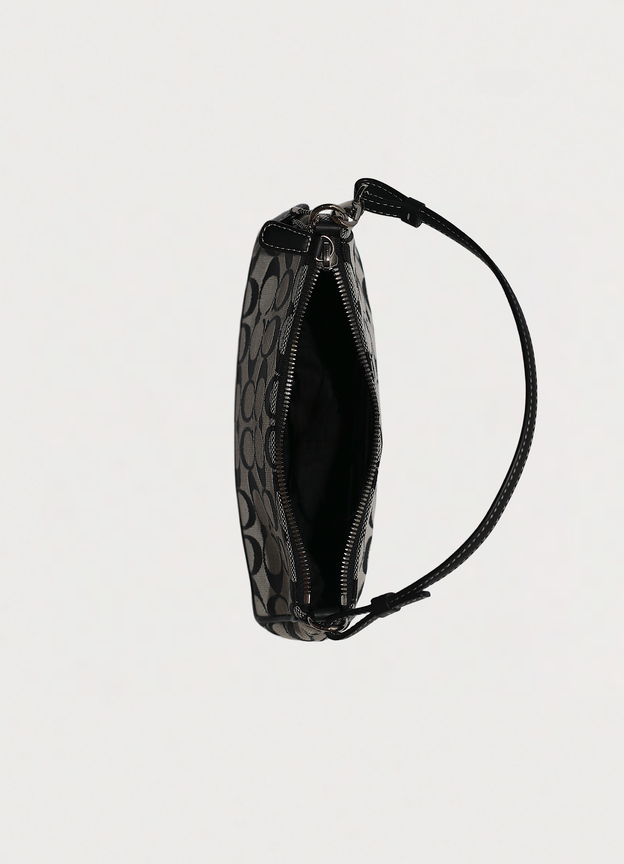 Top view into the Coach demi bag showing black fabric interior and zipper