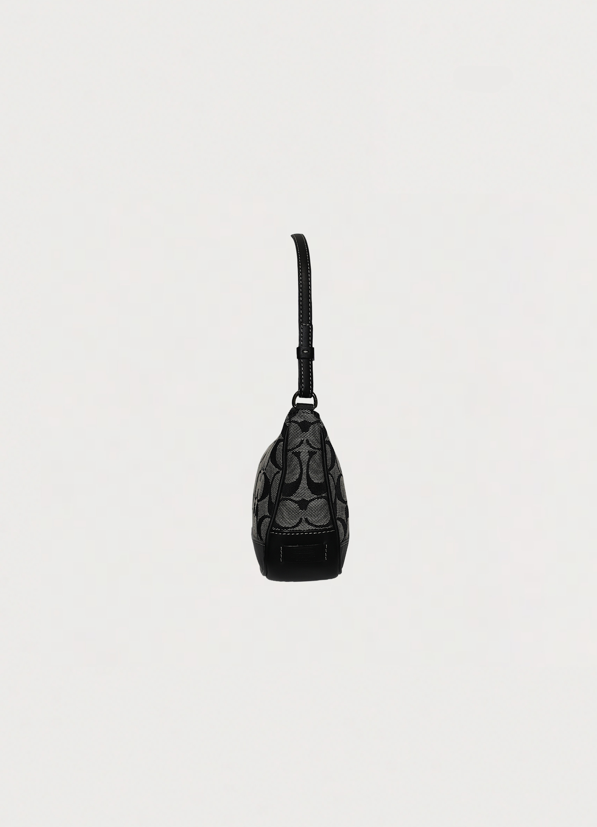 Left side profile of black Coach signature demi pochette bag