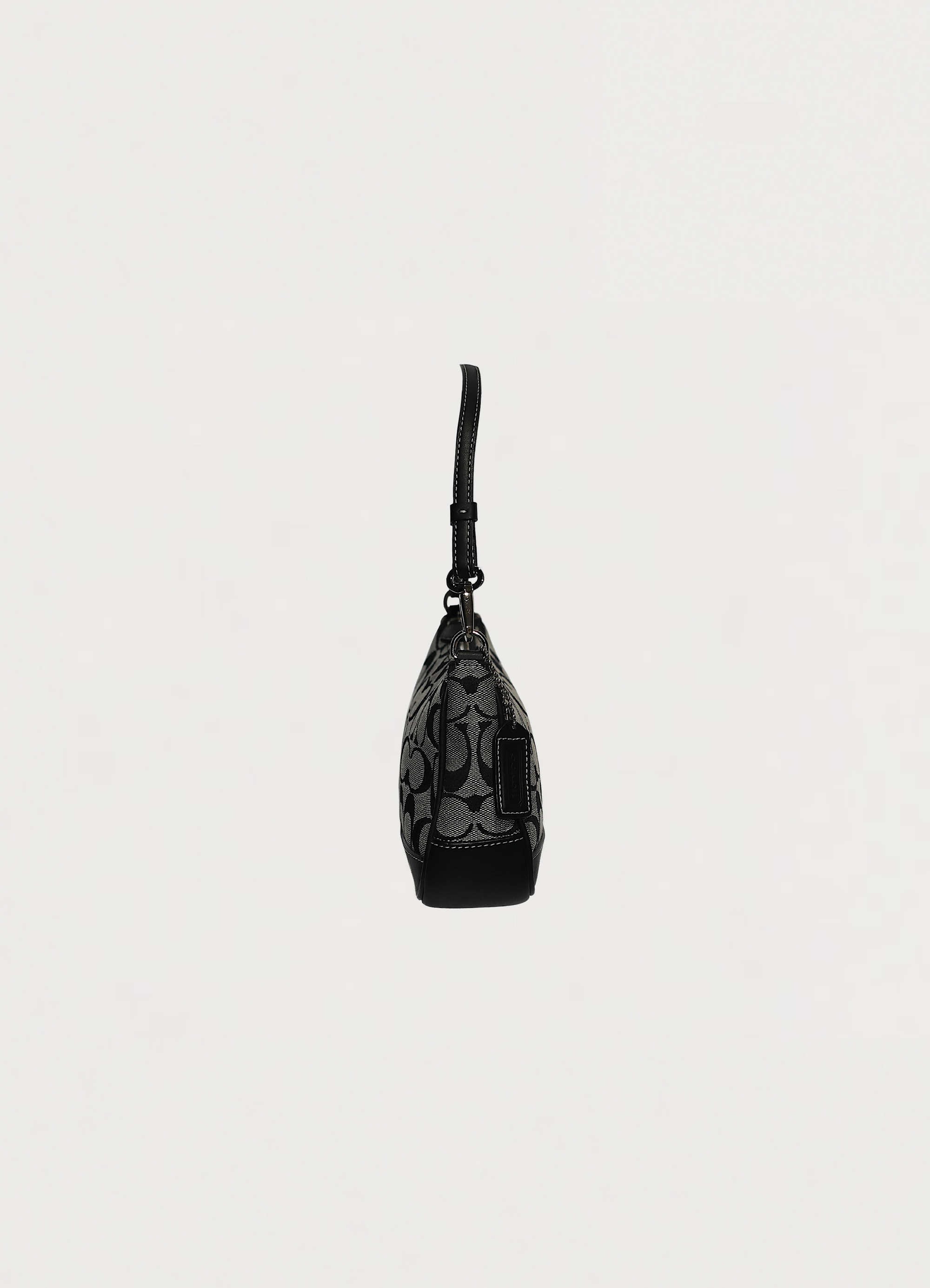 Right side profile of black Coach signature demi pochette bag