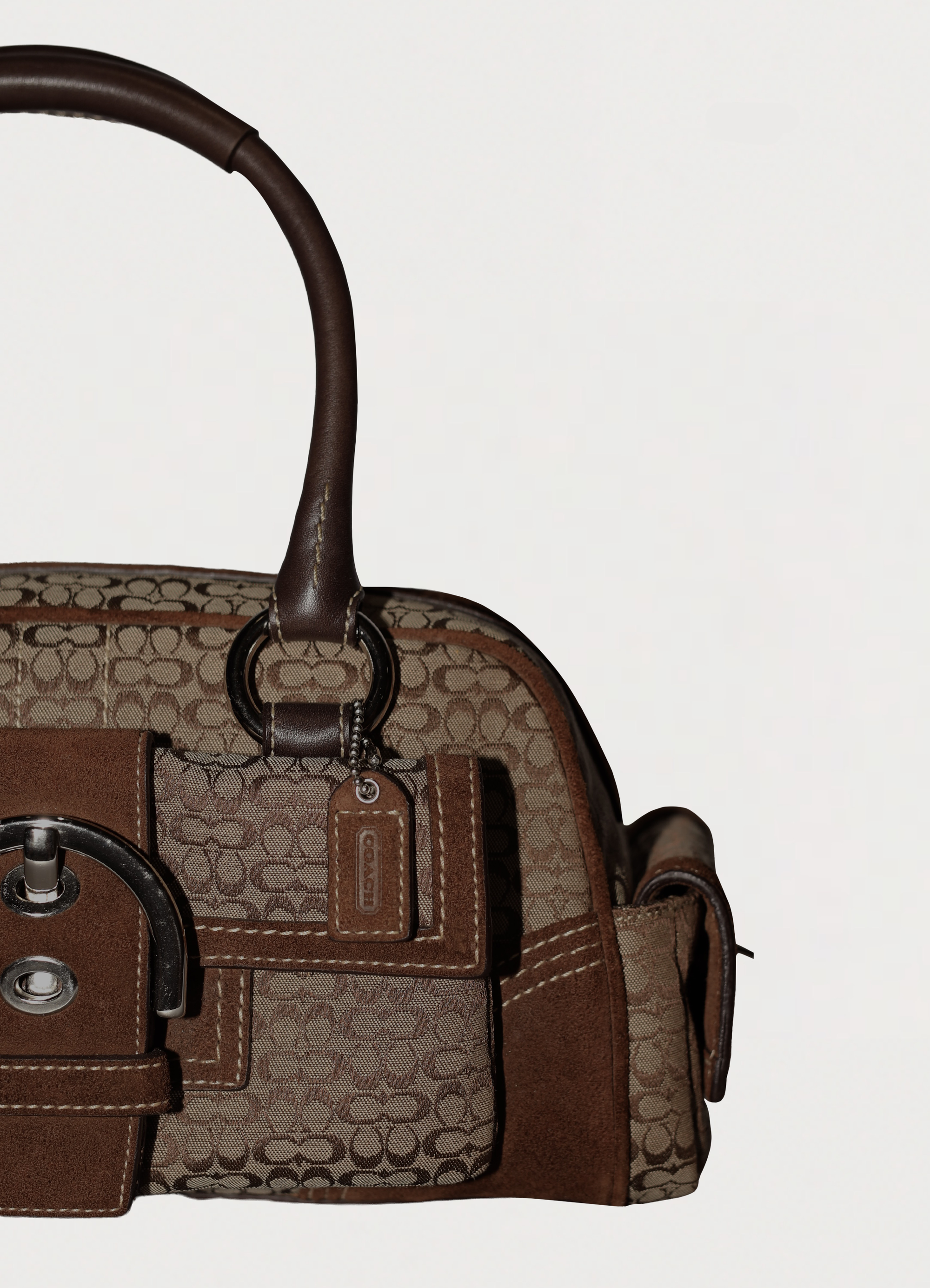 Vintage Coach Soho buckle satchel in brown signature canvas with leather trim with close up showing hang tag