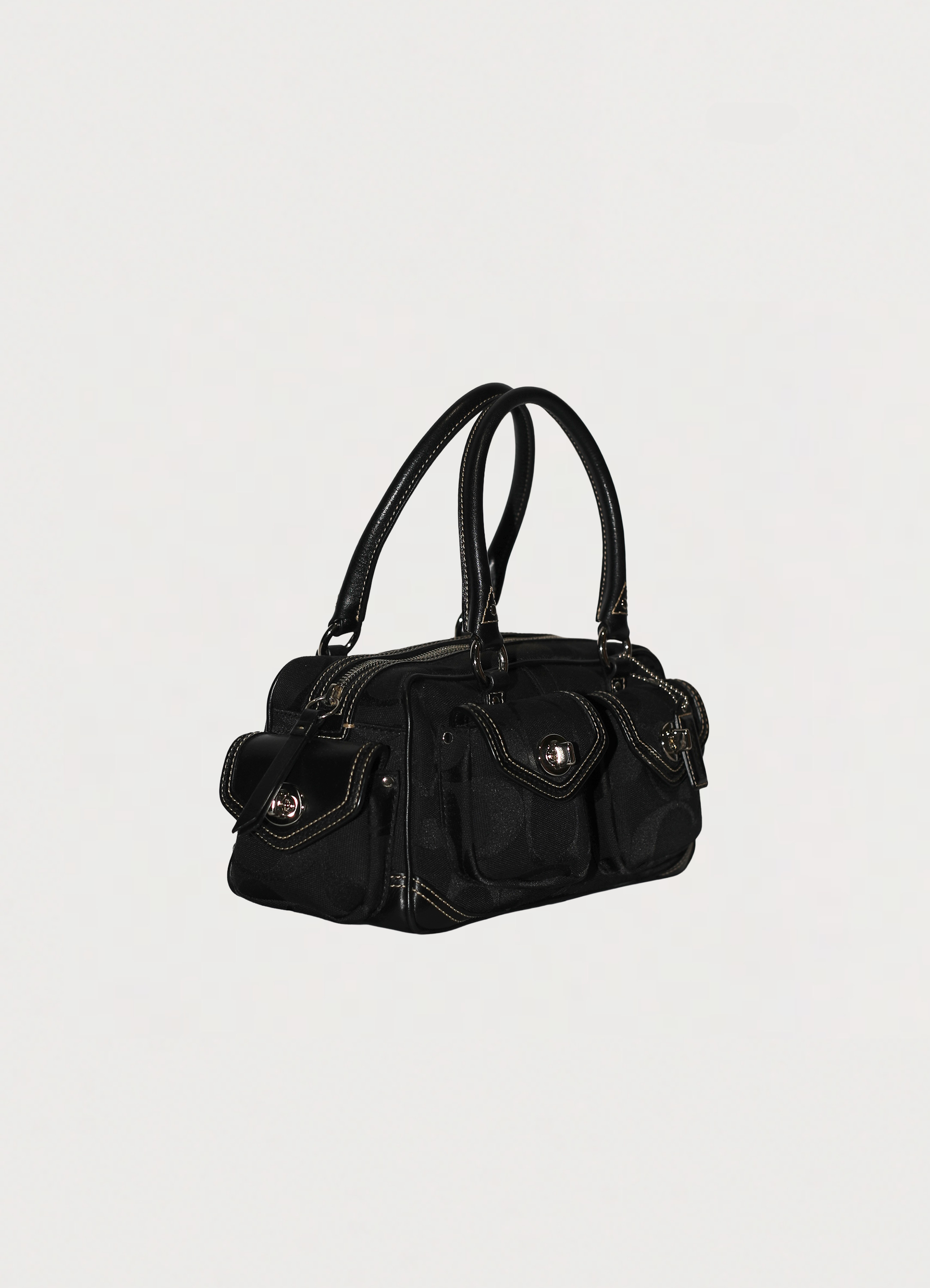 Vintage Coach Soho gallery satchel in black signature canvas with leather trim showing angle side
