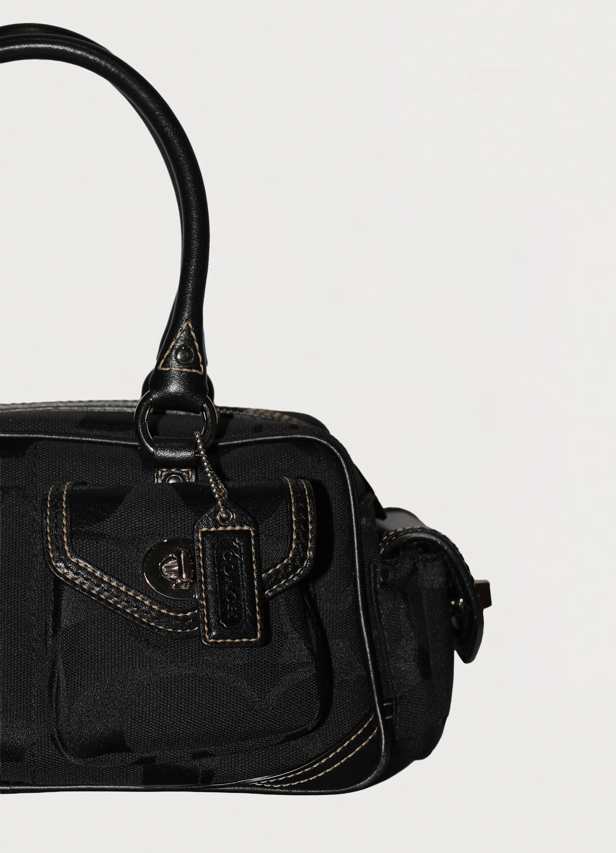 Vintage Coach Soho gallery satchel in black signature canvas with leather trim showing close up of hang tag