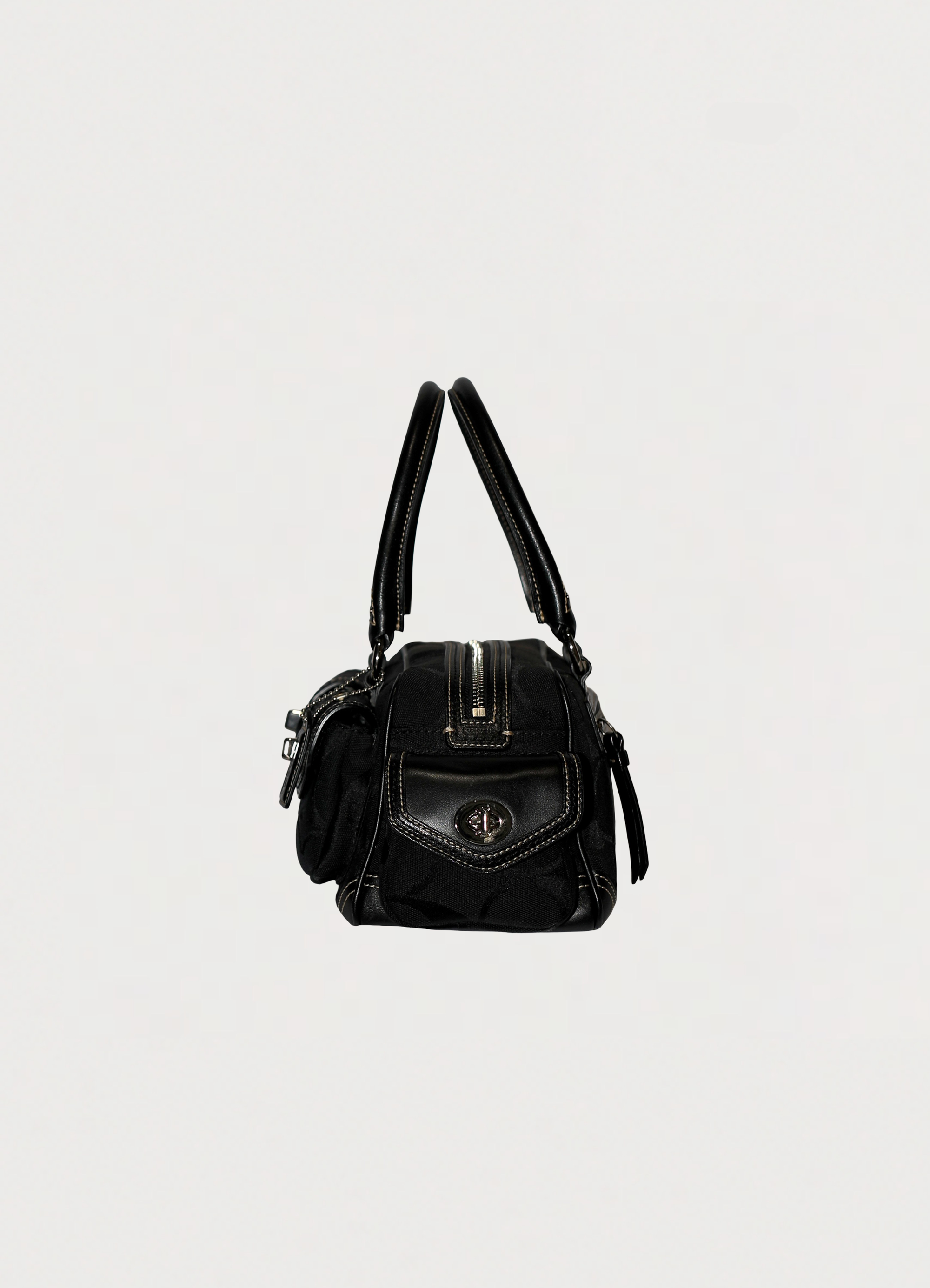 Vintage Coach Soho gallery satchel in black signature canvas with leather trim showing left side