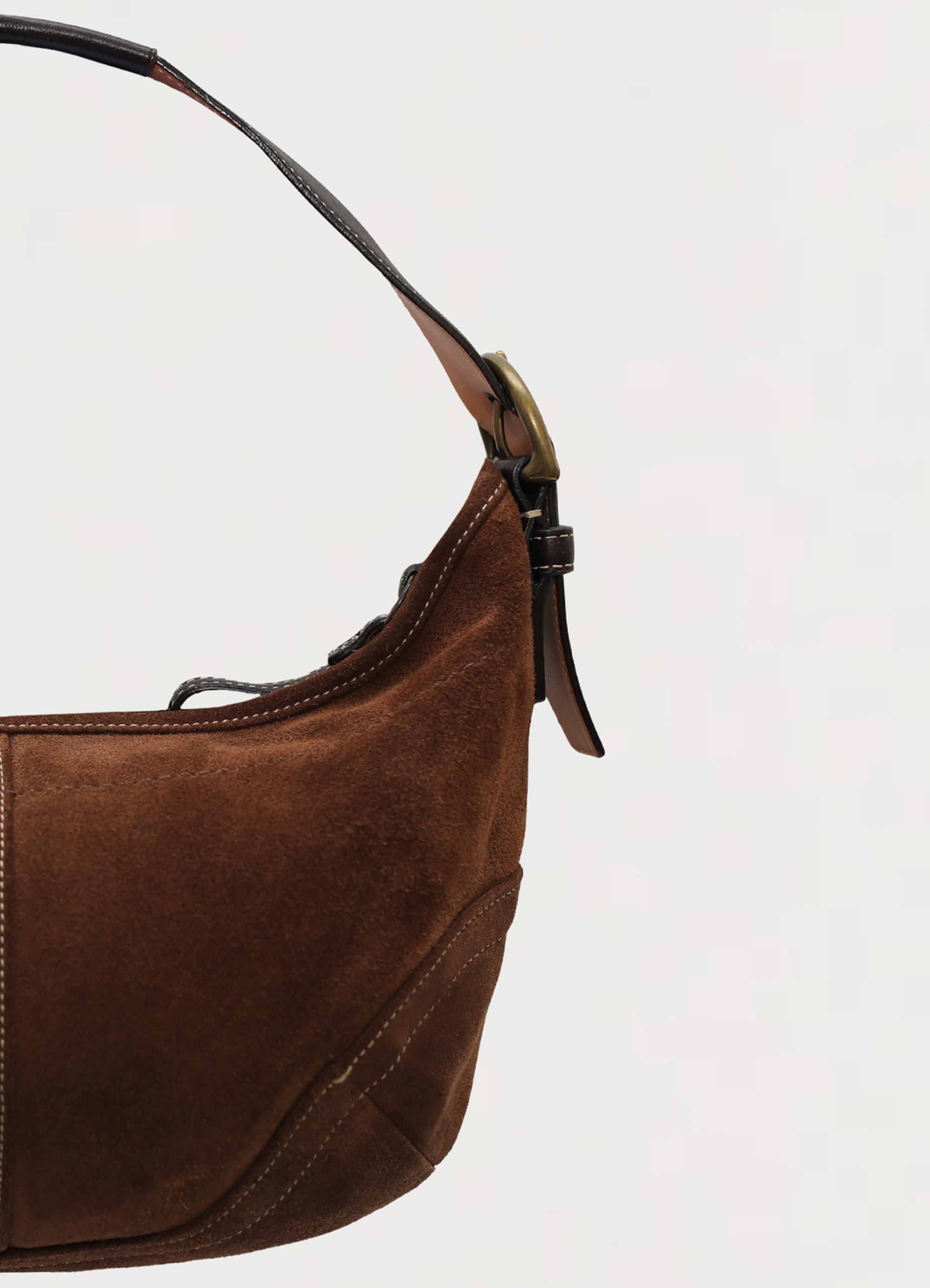 Vintage Coach Soho hobo bag in brown suede with leather trim showing close up of left side