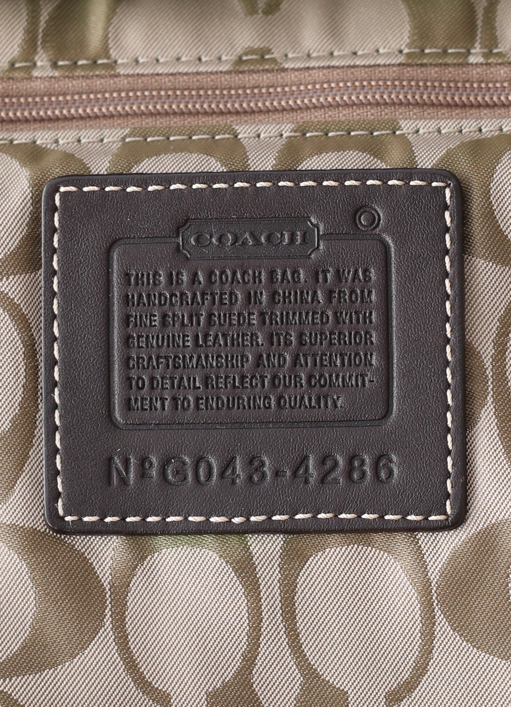 Vintage Coach Soho hobo bag in brown suede with leather trim showing close up of creed patch
