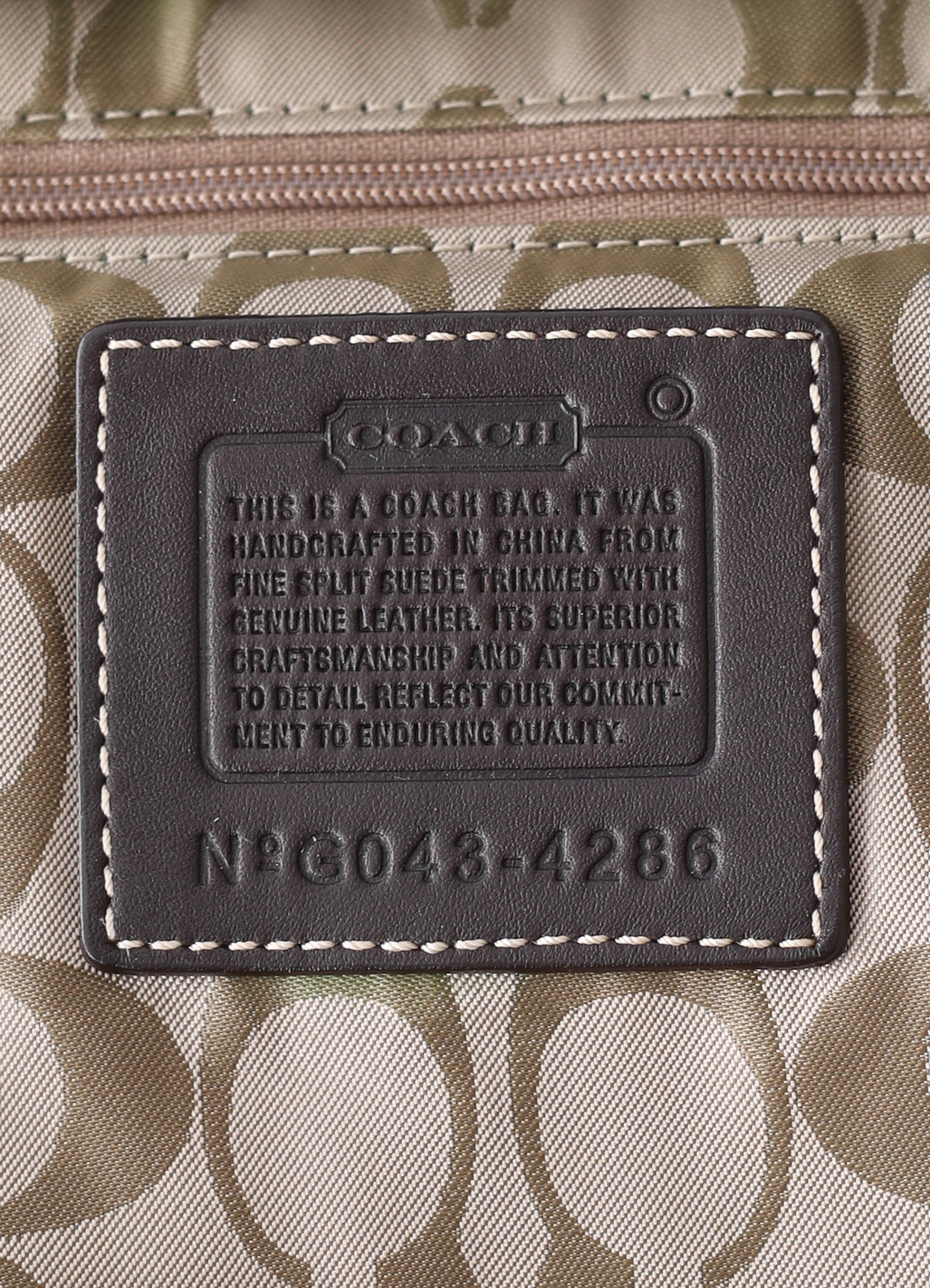 Vintage Coach Soho hobo bag in brown suede with leather trim showing close up of creed patch