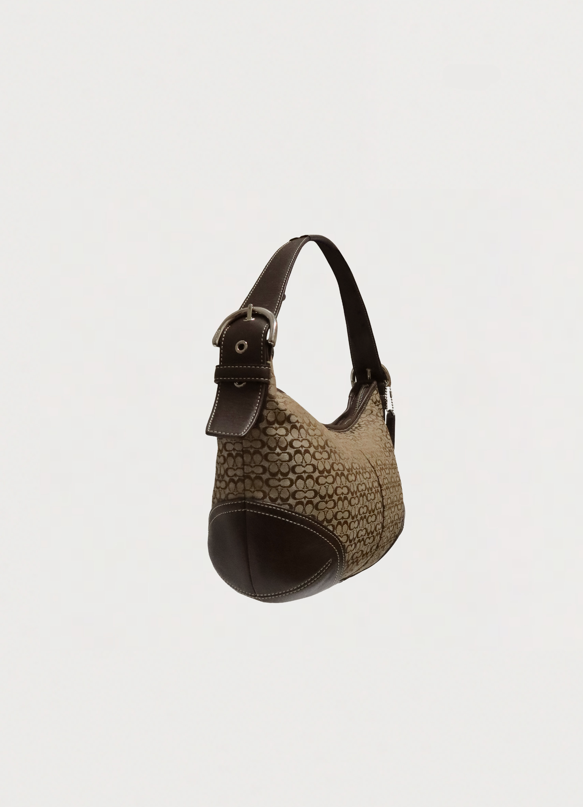 Angled side view of Coach Soho hobo showing the crescent silhouette